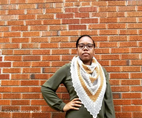 Tacia McIntosh of Joanna's Crochet Things in a cream and gold triangle crochet scarf