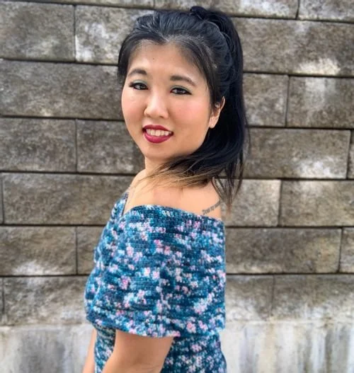 Cyn L of Original Cyn Creations in an off-the-shoulder blue floral top