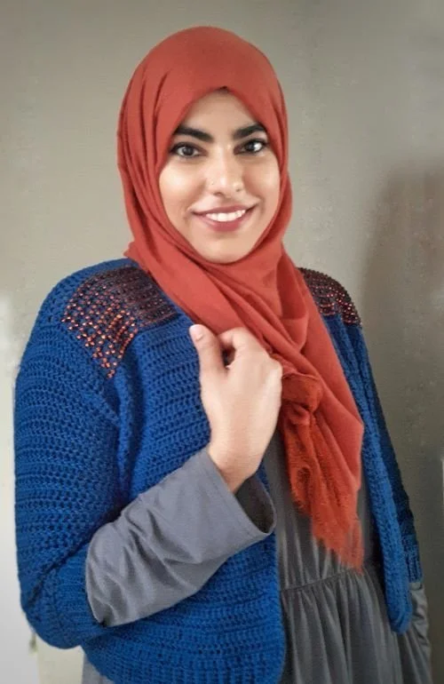 Fatima Nasir of Aquarius Make in a rust hijab and a blue crochet cardigan