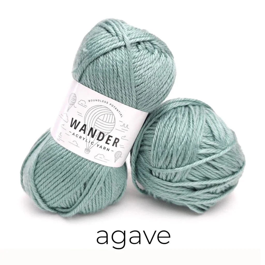 Skeins of Furls Wander yarn in Agave, a soft sage green worsted weight yarn used for the Easy Drape Bandana.