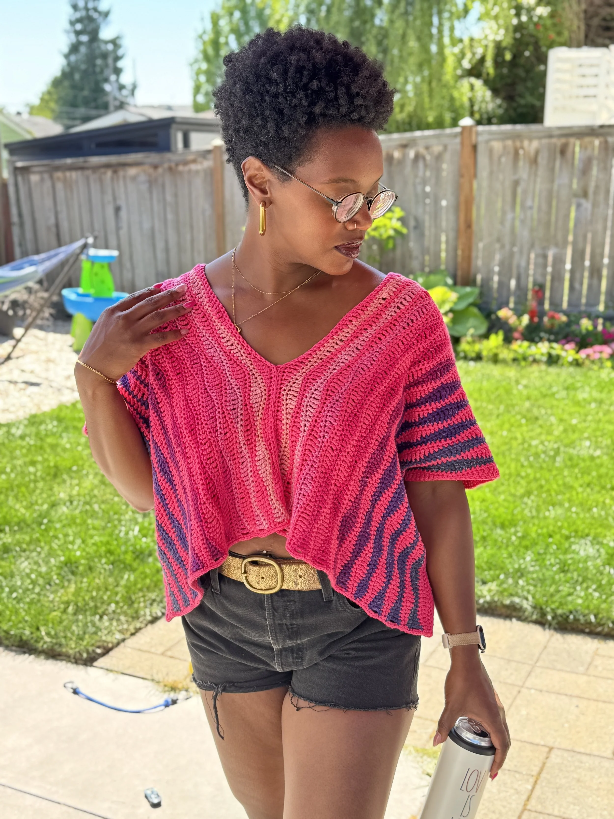 Pink and orange oversized crochet crop tee made with DK weight yarn, shown in a boxy fit with simple stitch texture and warm-weather styling.