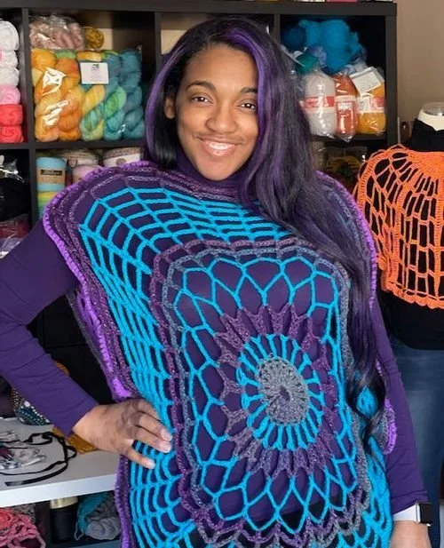 Courtney Whitehead of Creations by Courtney in a turquoise and purple mandala crochet top