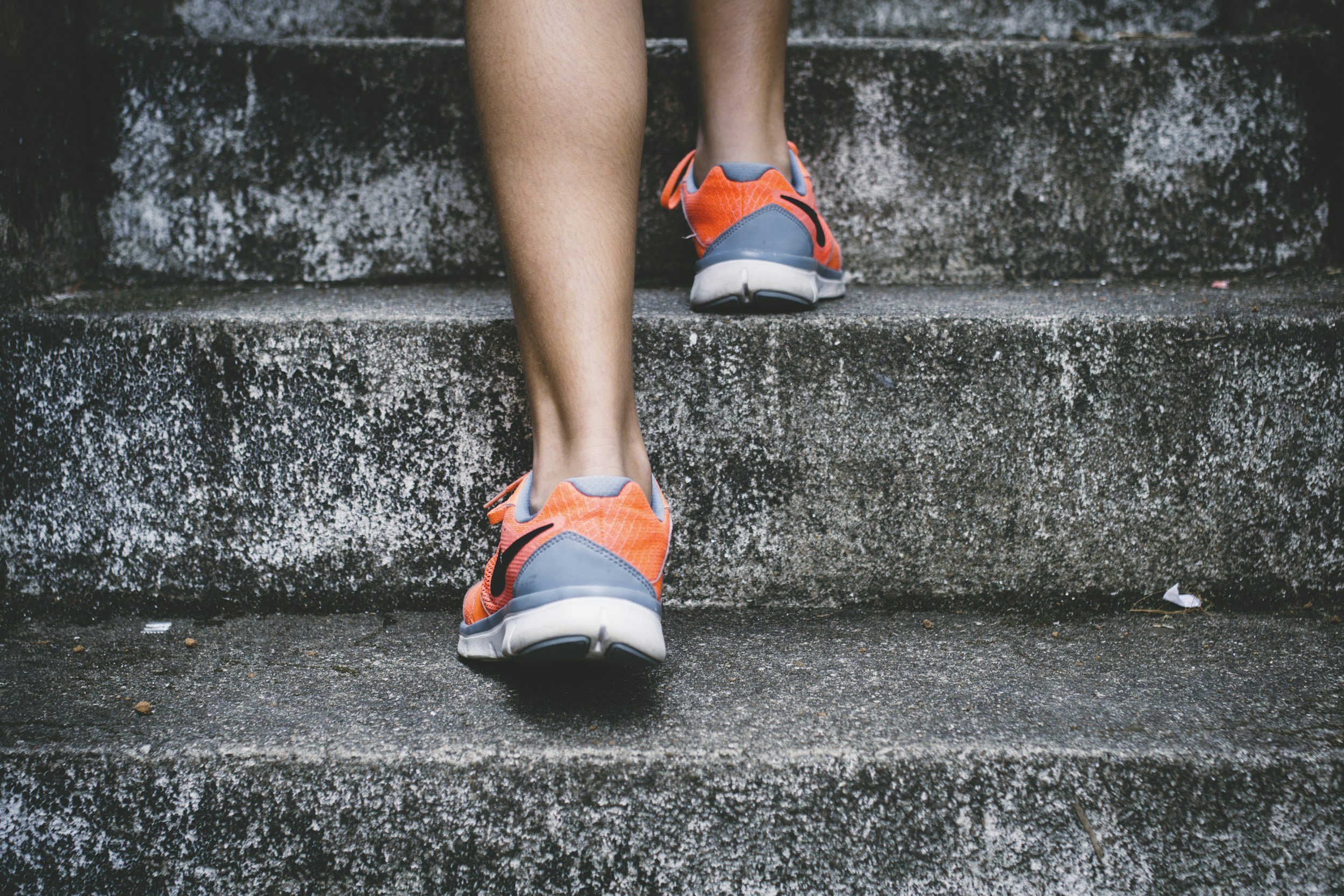 person in sneakers walking up concrete stairs signifying taking the step towards change with Soul Journey Therapy & Coaching Services