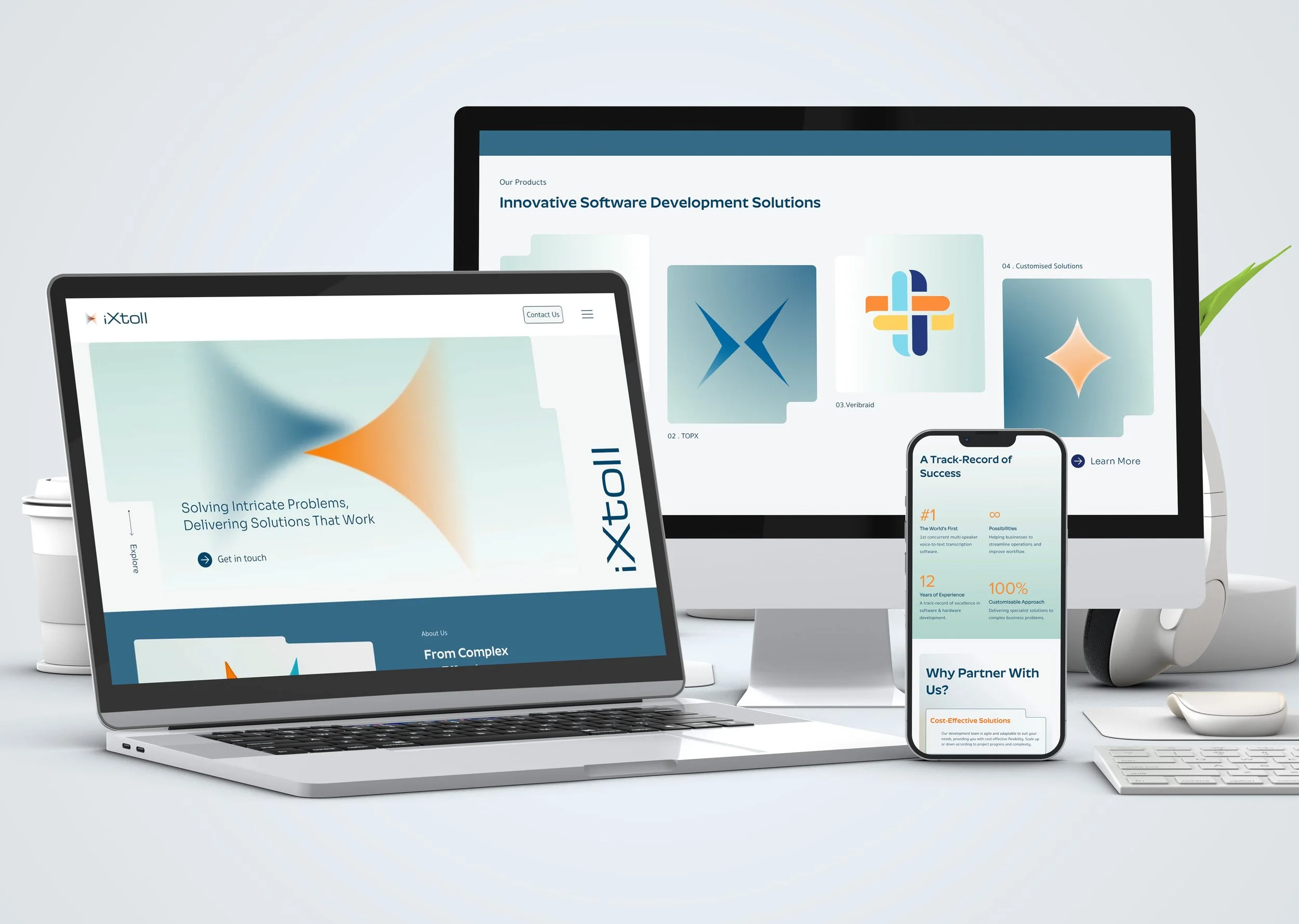 Multiple electronic devices displaying a website related to software development solutions, including a laptop, smartphones, and monitors with various colorful website pages.