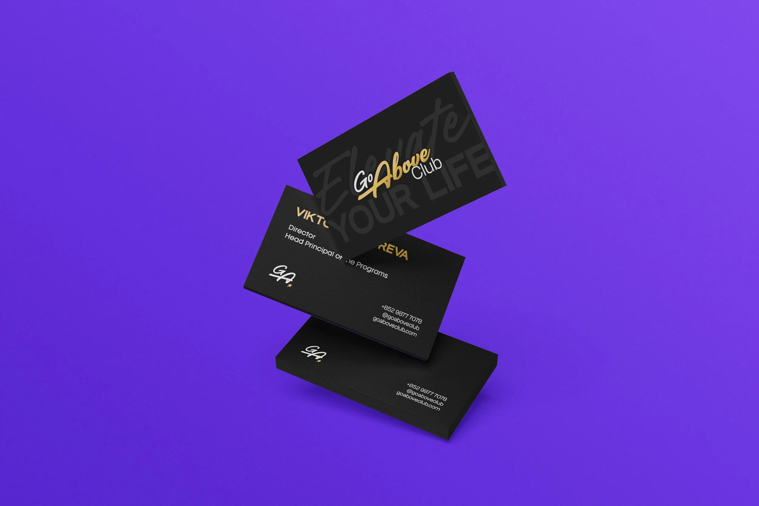 Business cards for Go Above Club with black background and gold, white, and gray text, floating over a purple background.