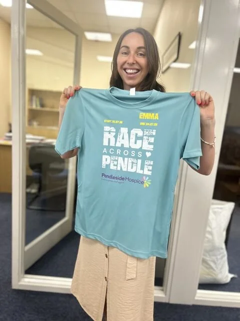 Emma Moore holding race across pendle t shirt front.jpg