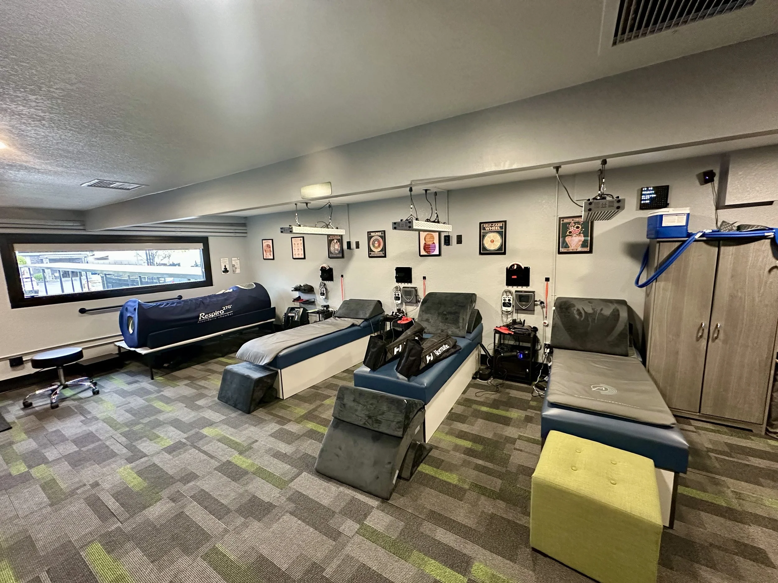 Recovery room with various tables and equipment for paralysis recovery.