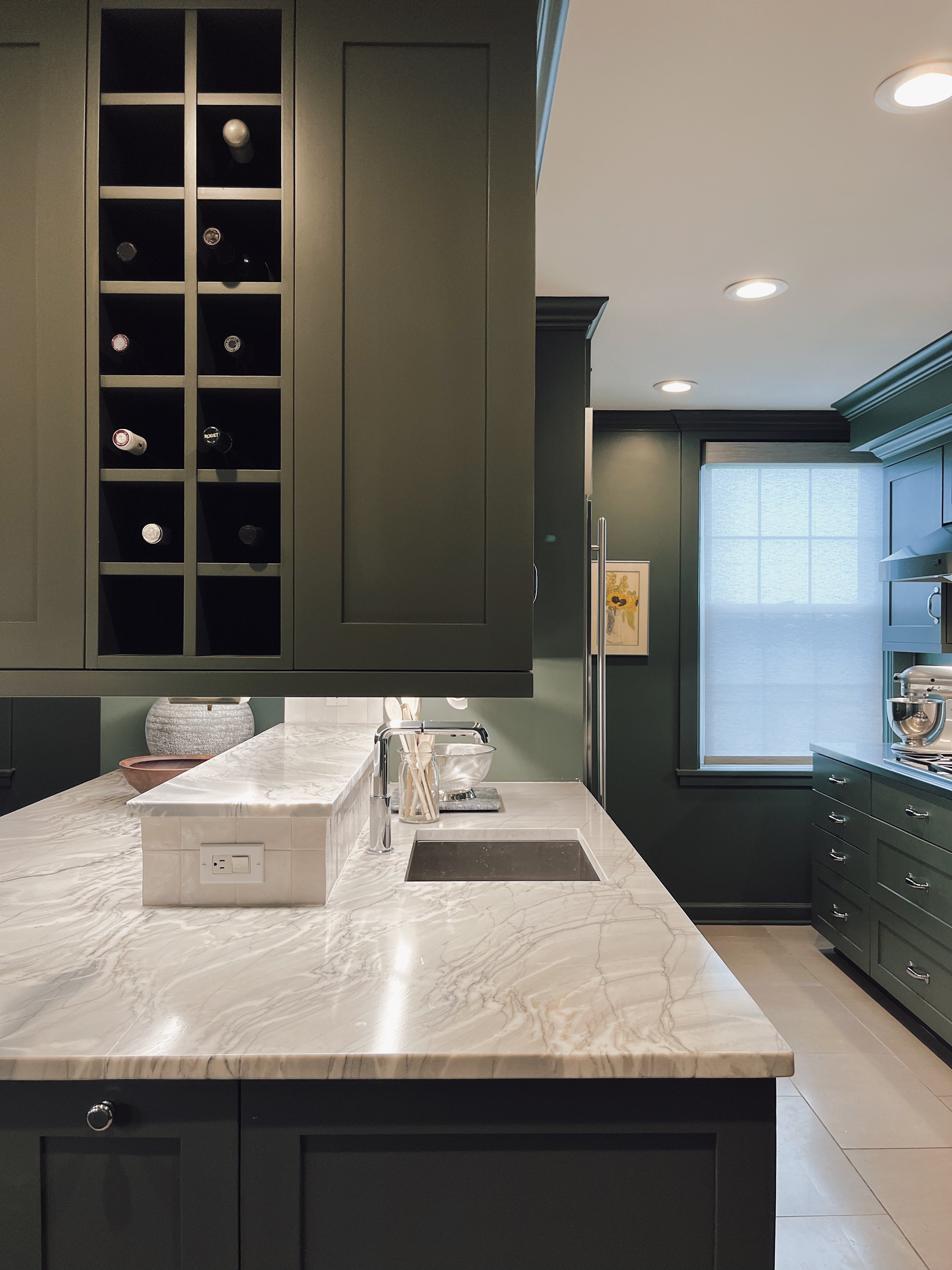  kitchen, kitchen cabinets, green kitchen, neutral backsplash, quartzite countertops, stone floor, moody kitchen, elegant, dramatic  