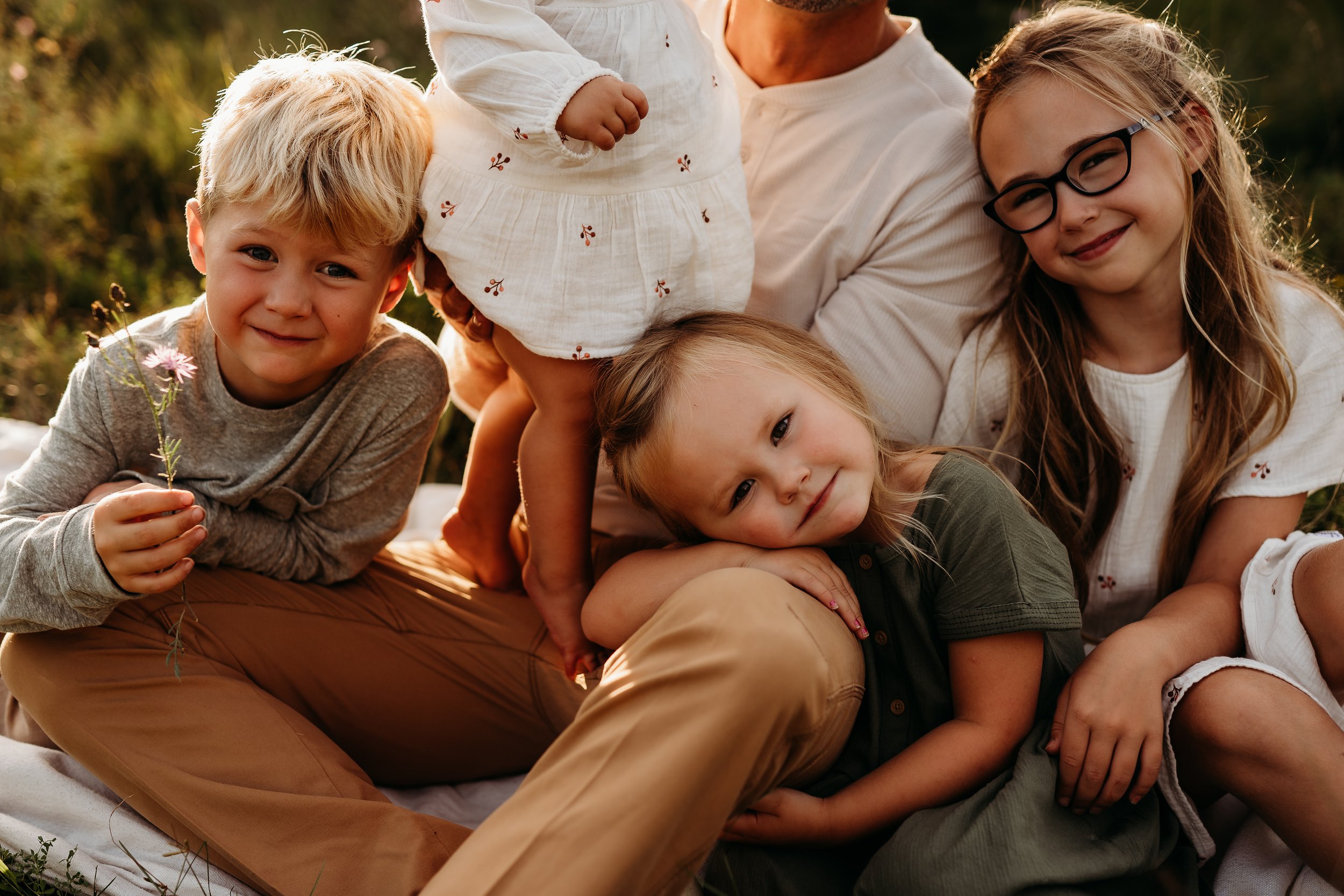 Dad small children cuddle outside.jpg