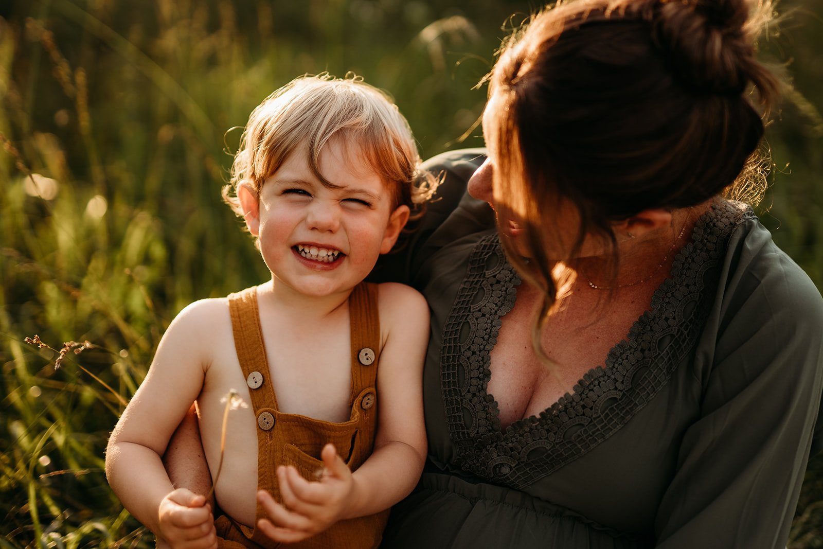 Little boy smiling mom lap.jpg
