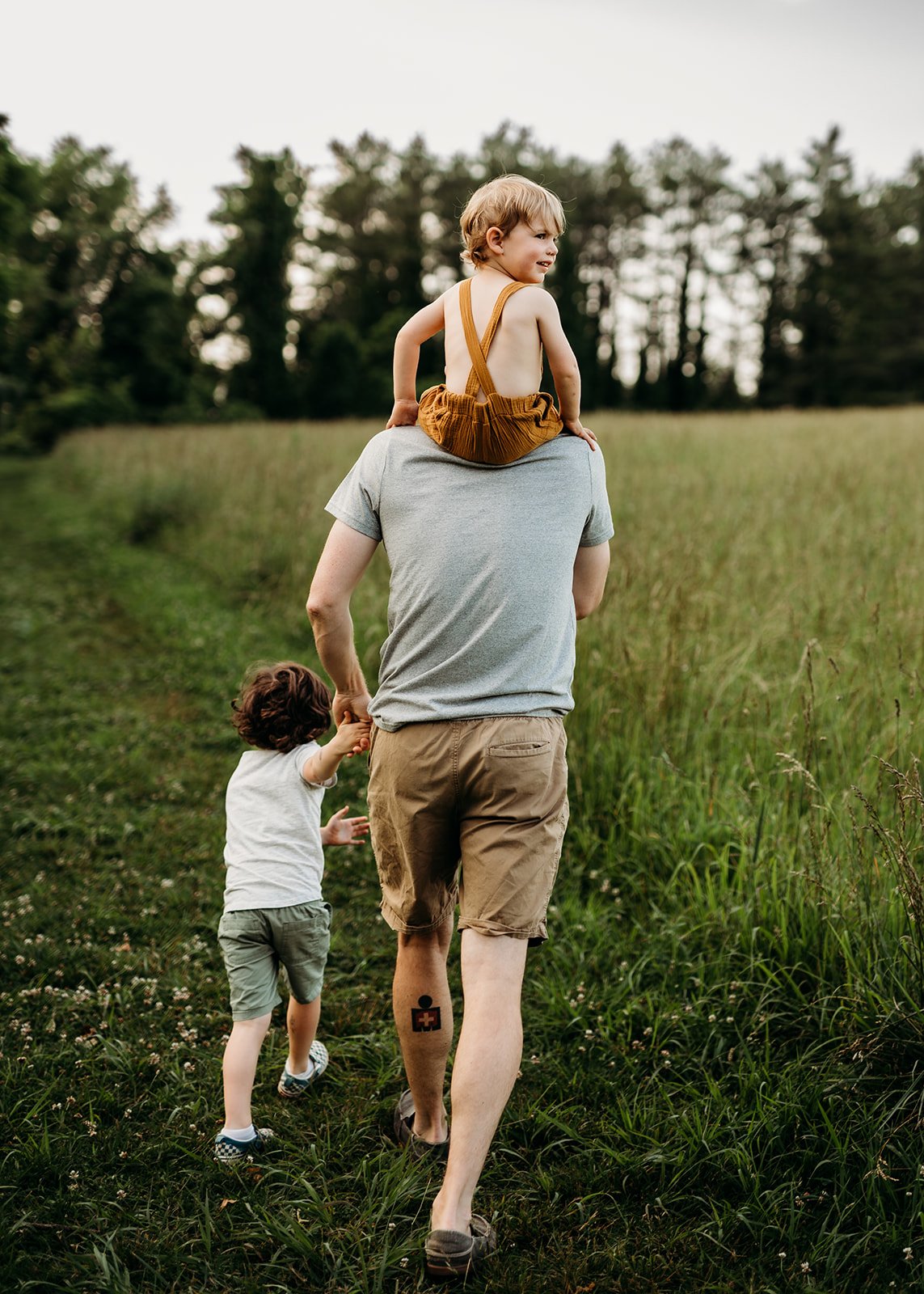 Little boy dad shoulders field.jpg