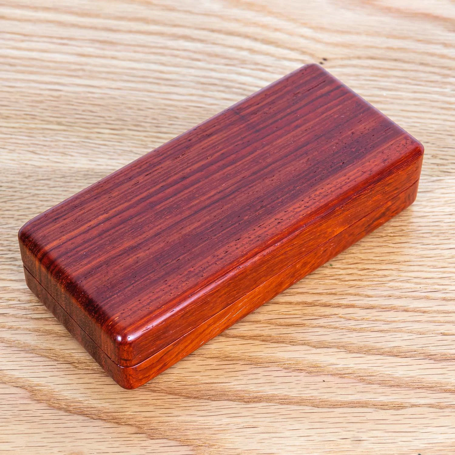 padauk-eyeglass-case-closed-wood-table-detail.jpg