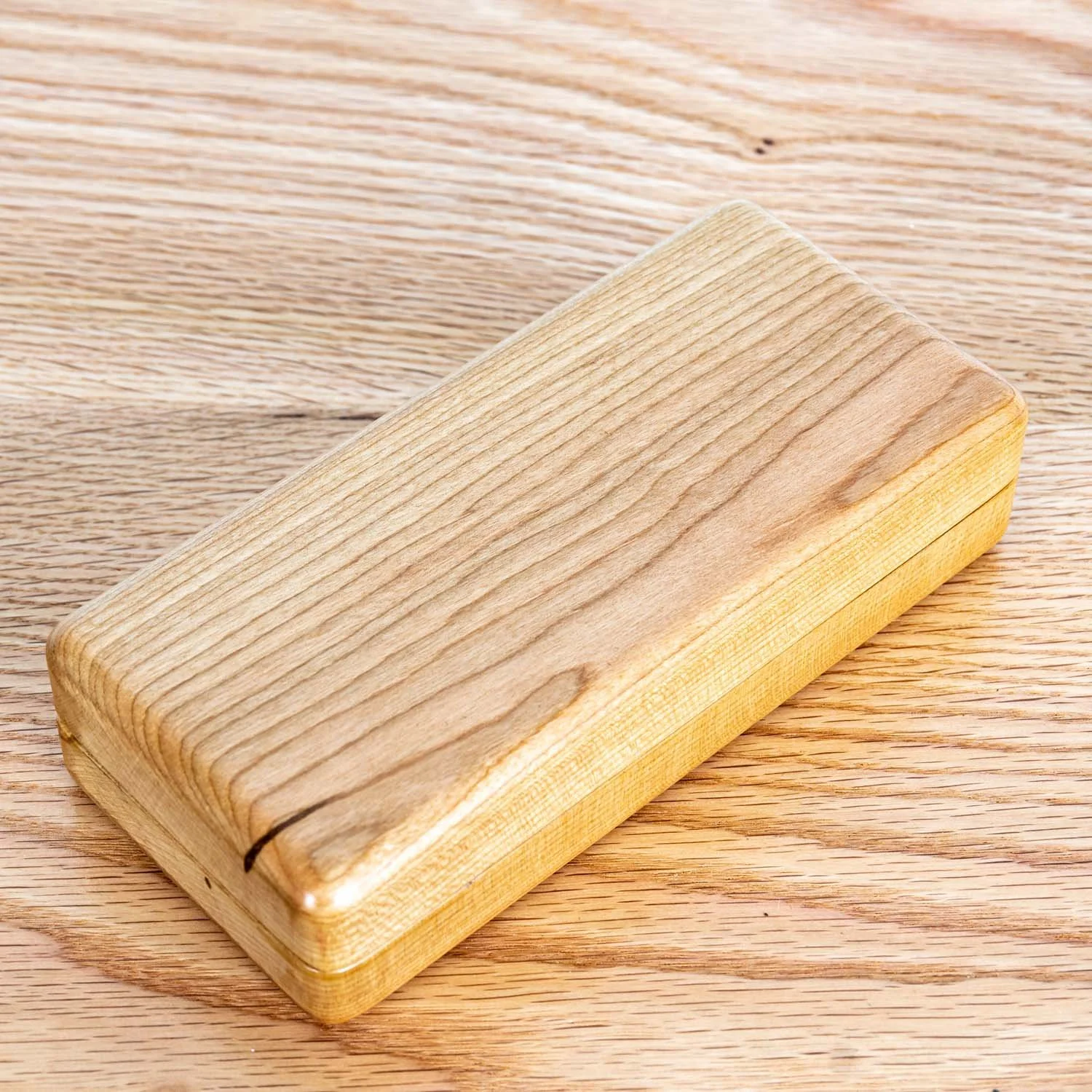 cherry-eyeglass-case-closed-wood-surface-tweatherheadco.jpg