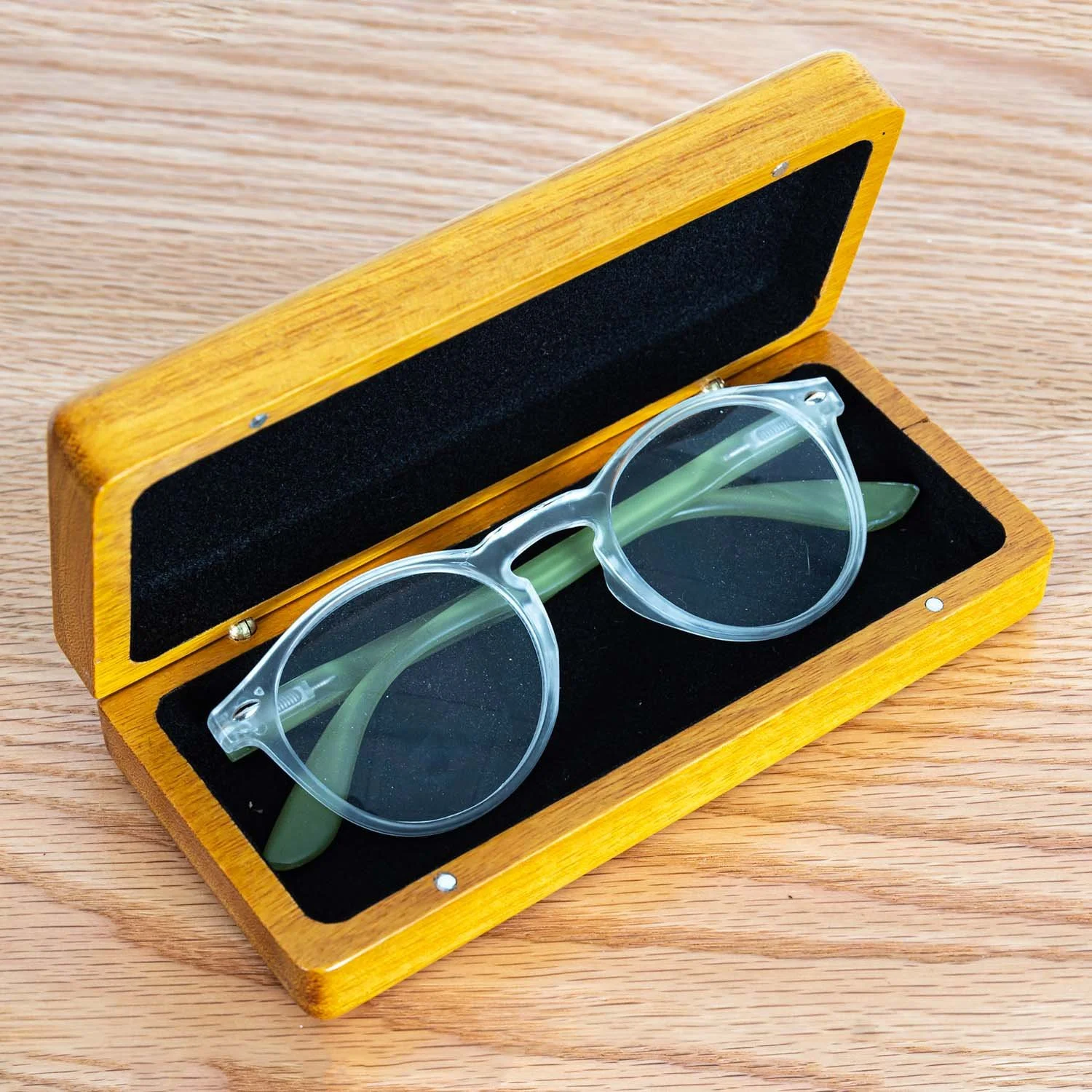 open-osage-orange-eyeglass-case-clear-frames-wood-surface.jpg