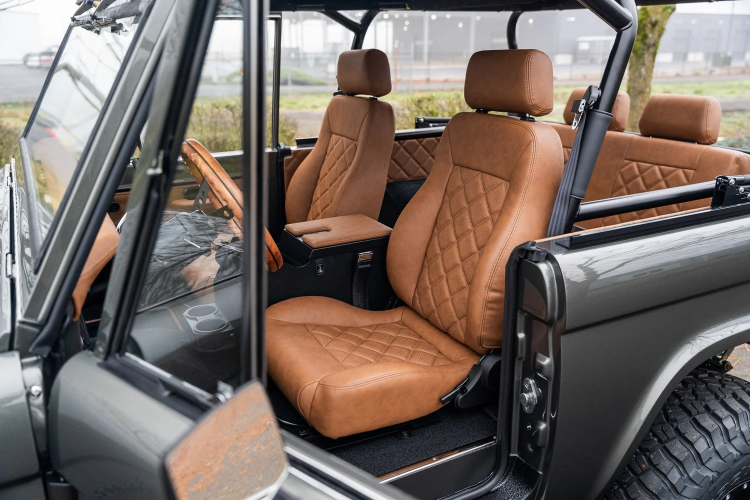 Hand-stitched tan leather seats and matching interior inside a HighLine Bronco