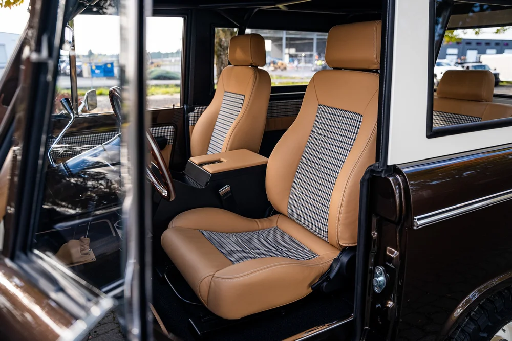 Custom tan and houndstooth seating in a HighLine Classics Bronco.