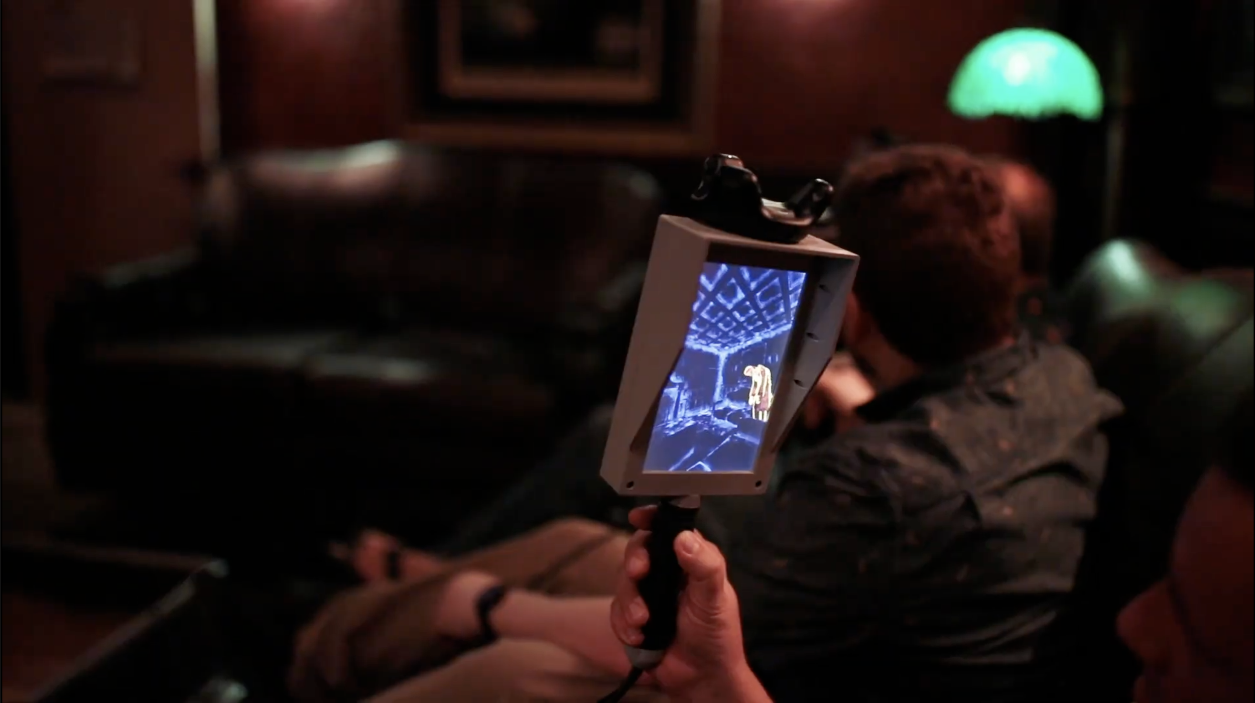 Person holding a digital screen device with a ghost depicted