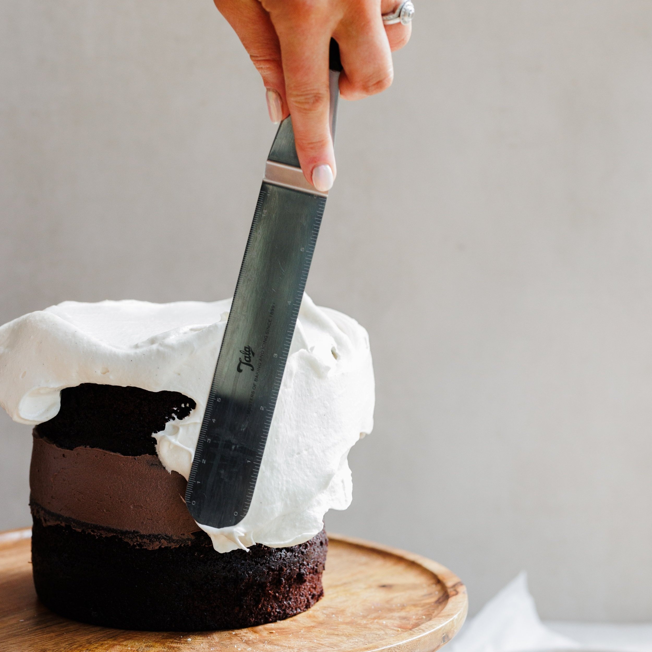 Vanilla Marshmallow Fluff by The Mallow Makers covering a chocolate cake