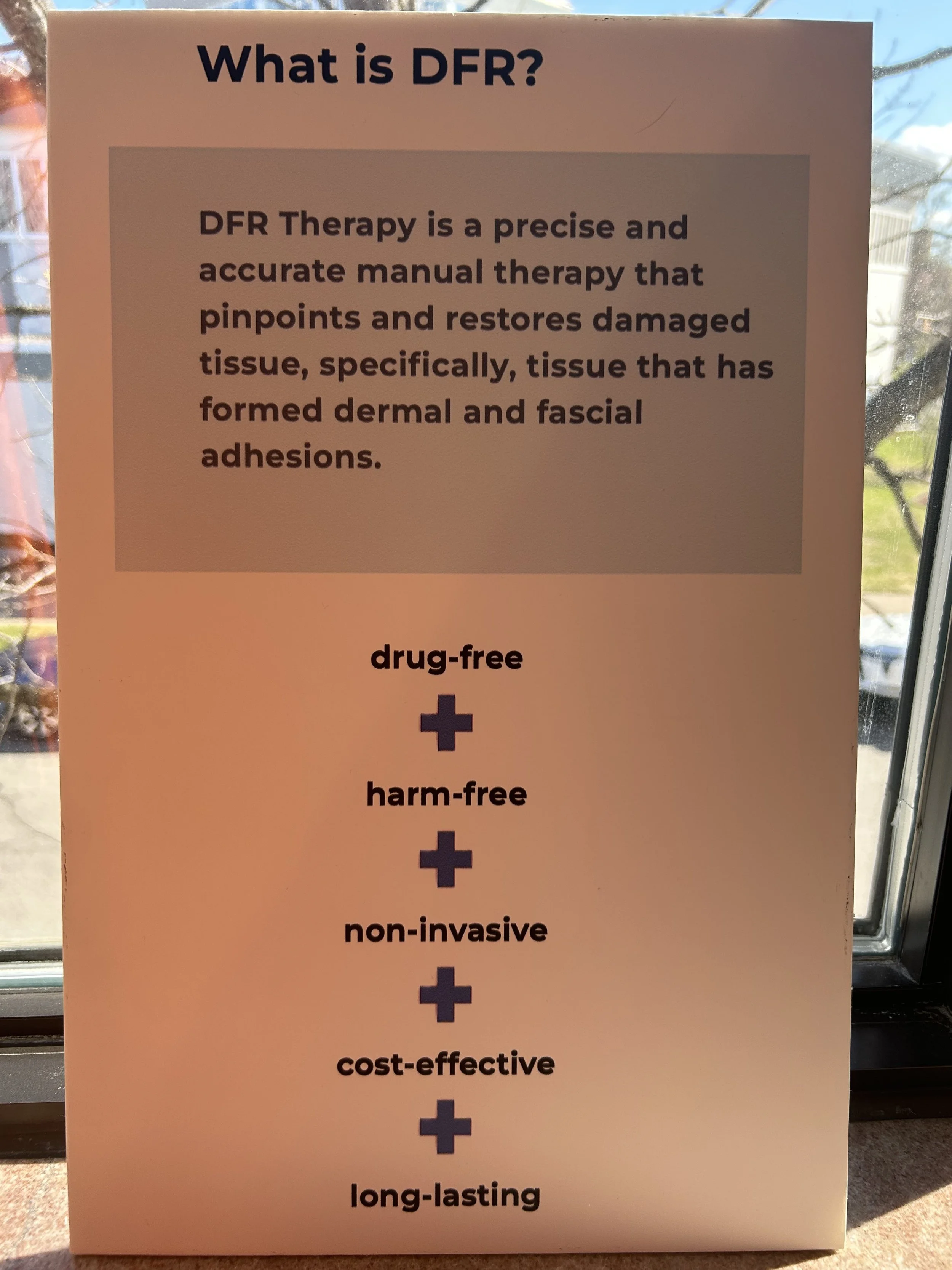 A sign explaining the features of DFR therapy, emphasizing that it is drug-free, harm-free, non-invasive, cost-effective, and long-lasting.