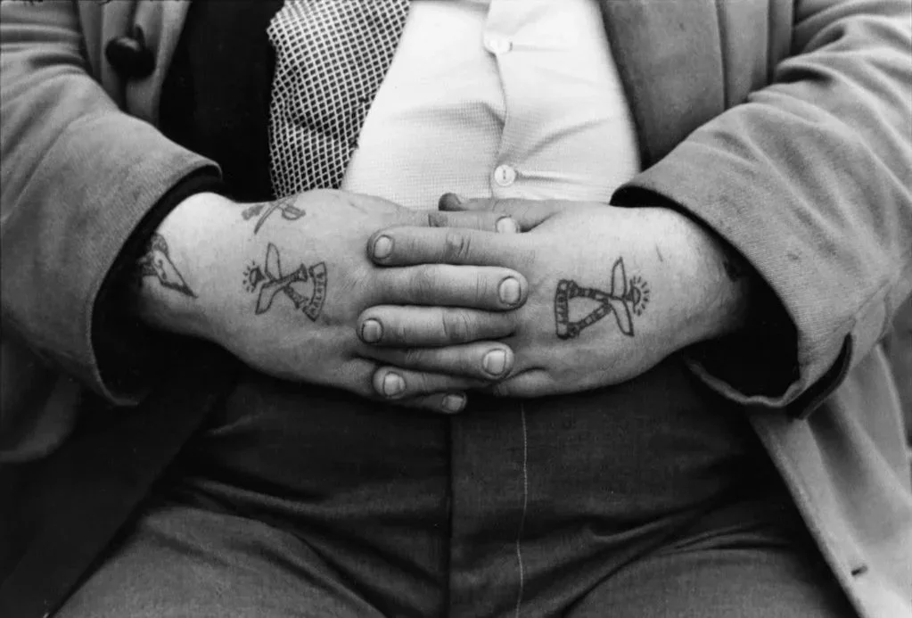 photograph of male hands showing symmetrical tattoos