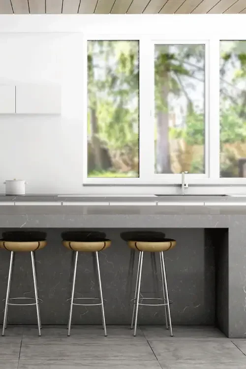 Grey modern kitchen with island and silver accessories