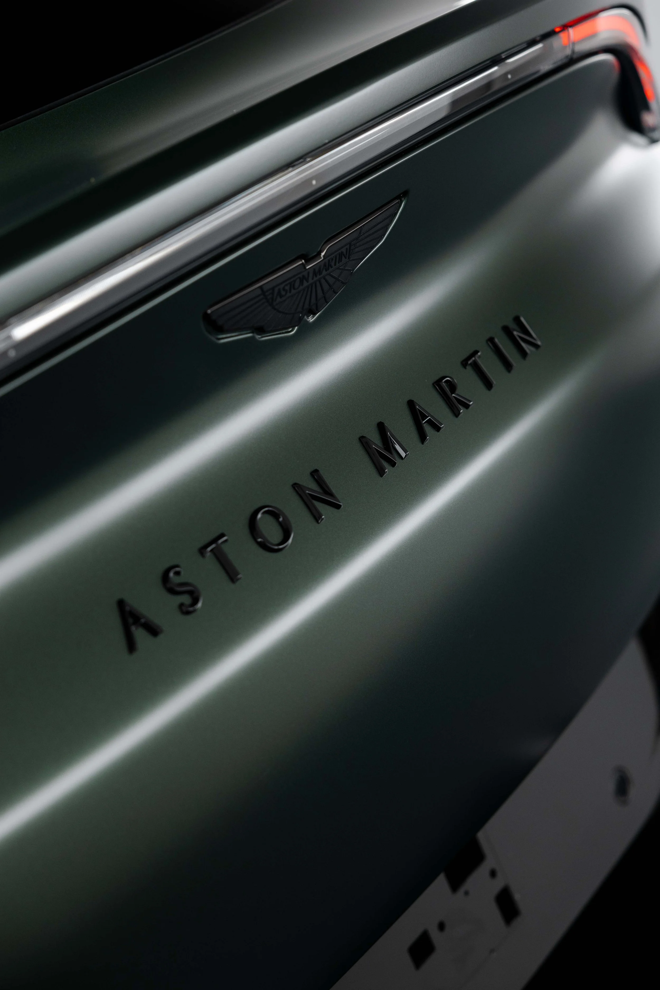 Matte green Aston Martin DBX Aston Martin badge and taillight with XPEL Stealth Paint Protection Film in Mona Vale