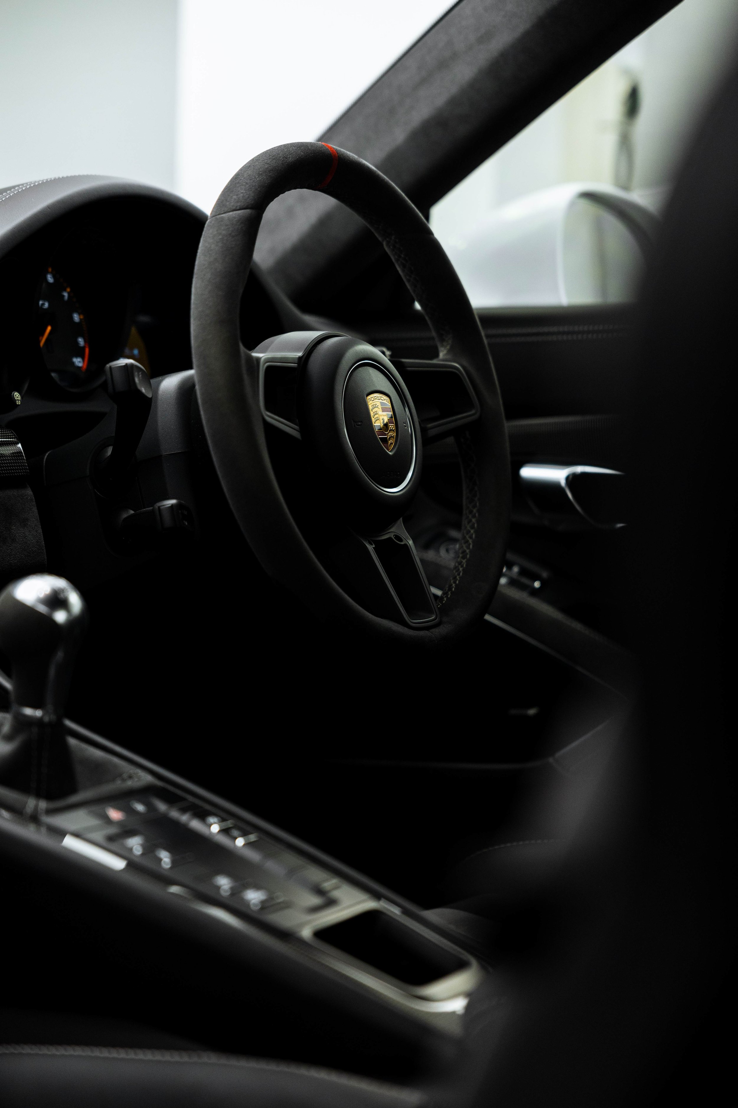 White Porsche GT3 interior detailing steering wheel and gear shifter in Sydney
