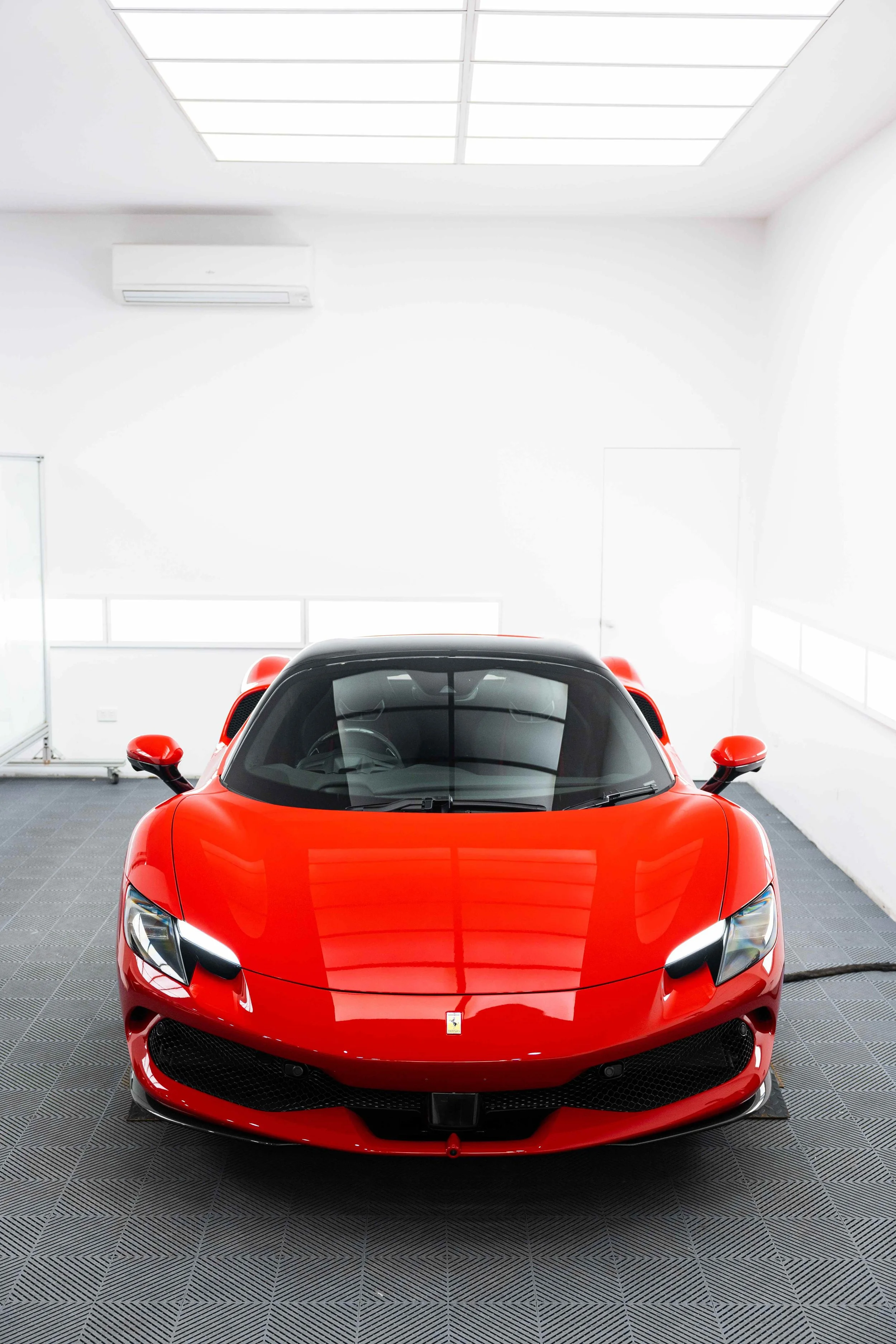 Red Ferrari 296 GTS front view in studio with XPEL Paint Protection Film in Mona Vale