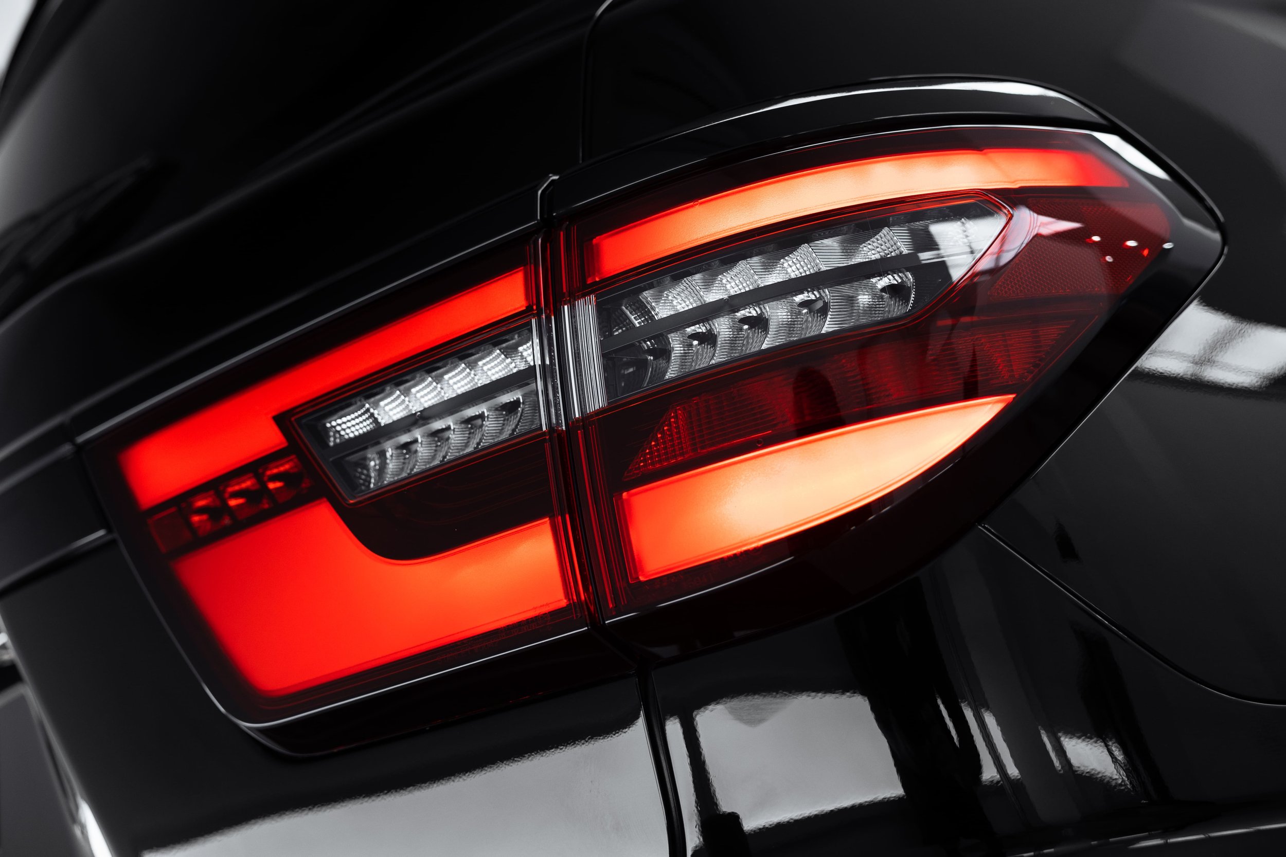 Close-up of Y62 Nissan Patrol rear tail light with glossy black finish after detailing by ADS in Sydney