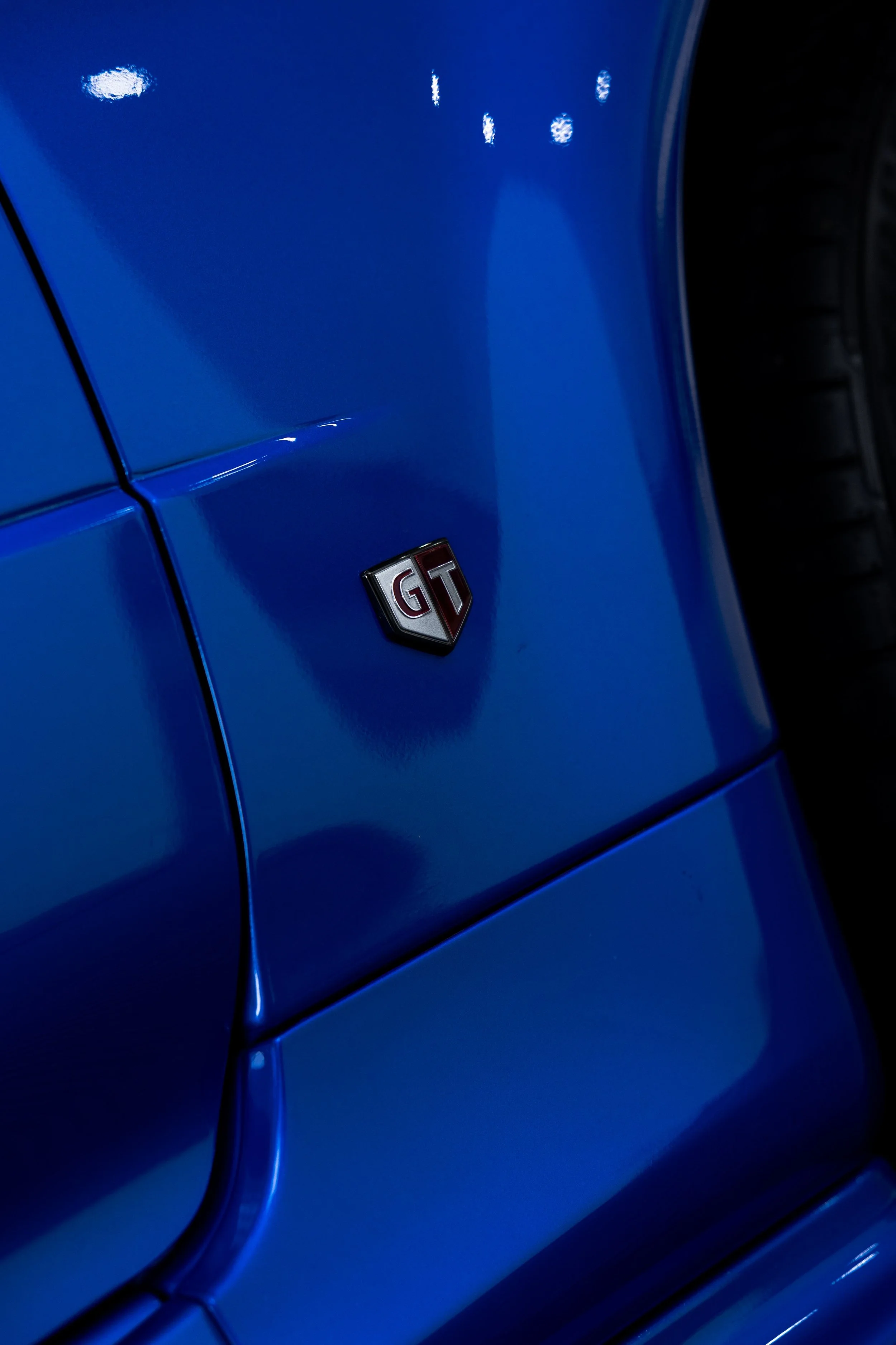 GT badge on bayside blue Nissan R34 GT-R Nur guard with XPEL Paint Protection Film in Mona Vale