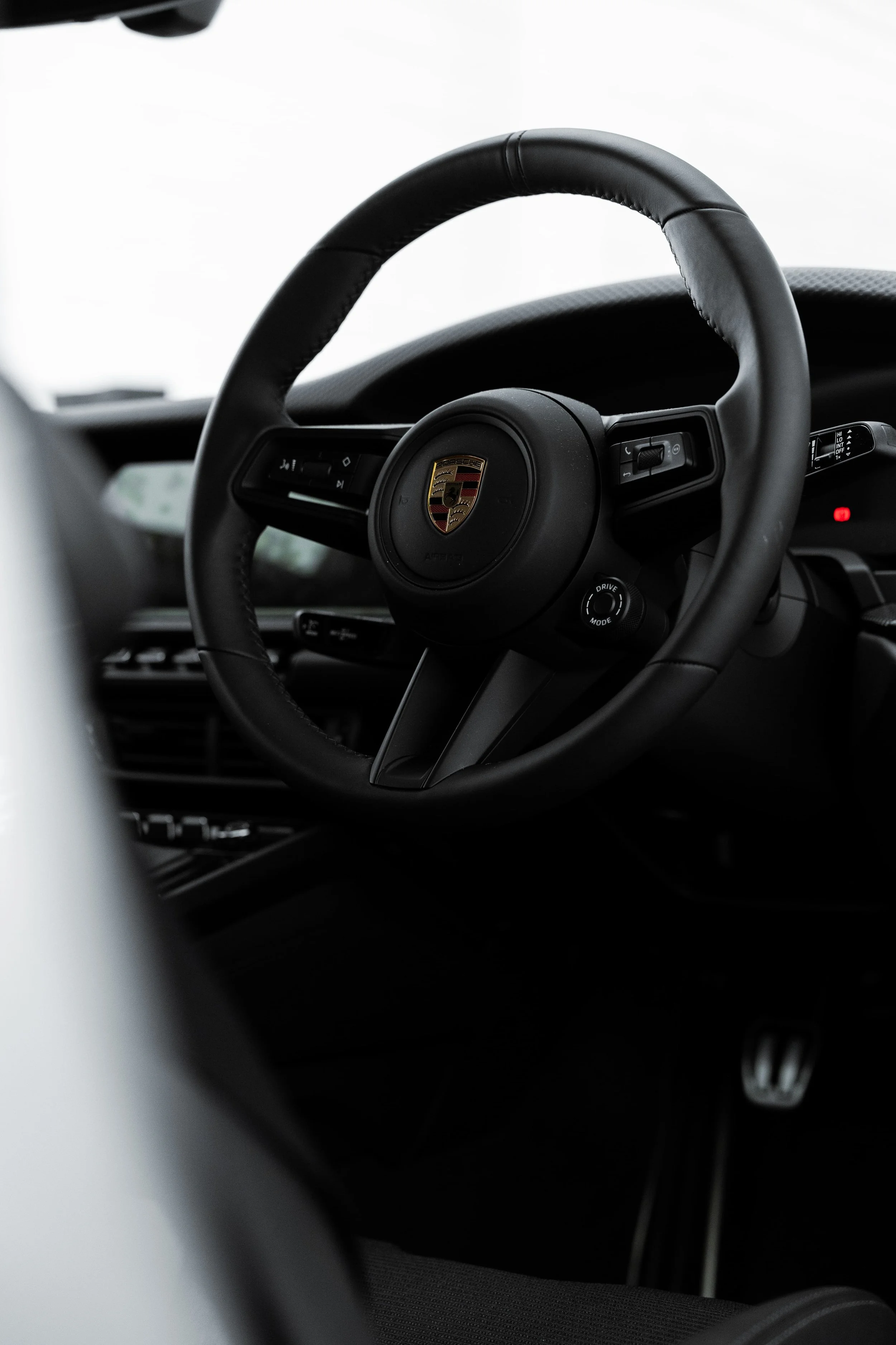 Porsche 911 GT3 Touring interior steering wheel with Porsche crest, showcasing minimalist driver-focused design and premium finish detailed by Australian Detailing Services Sydney