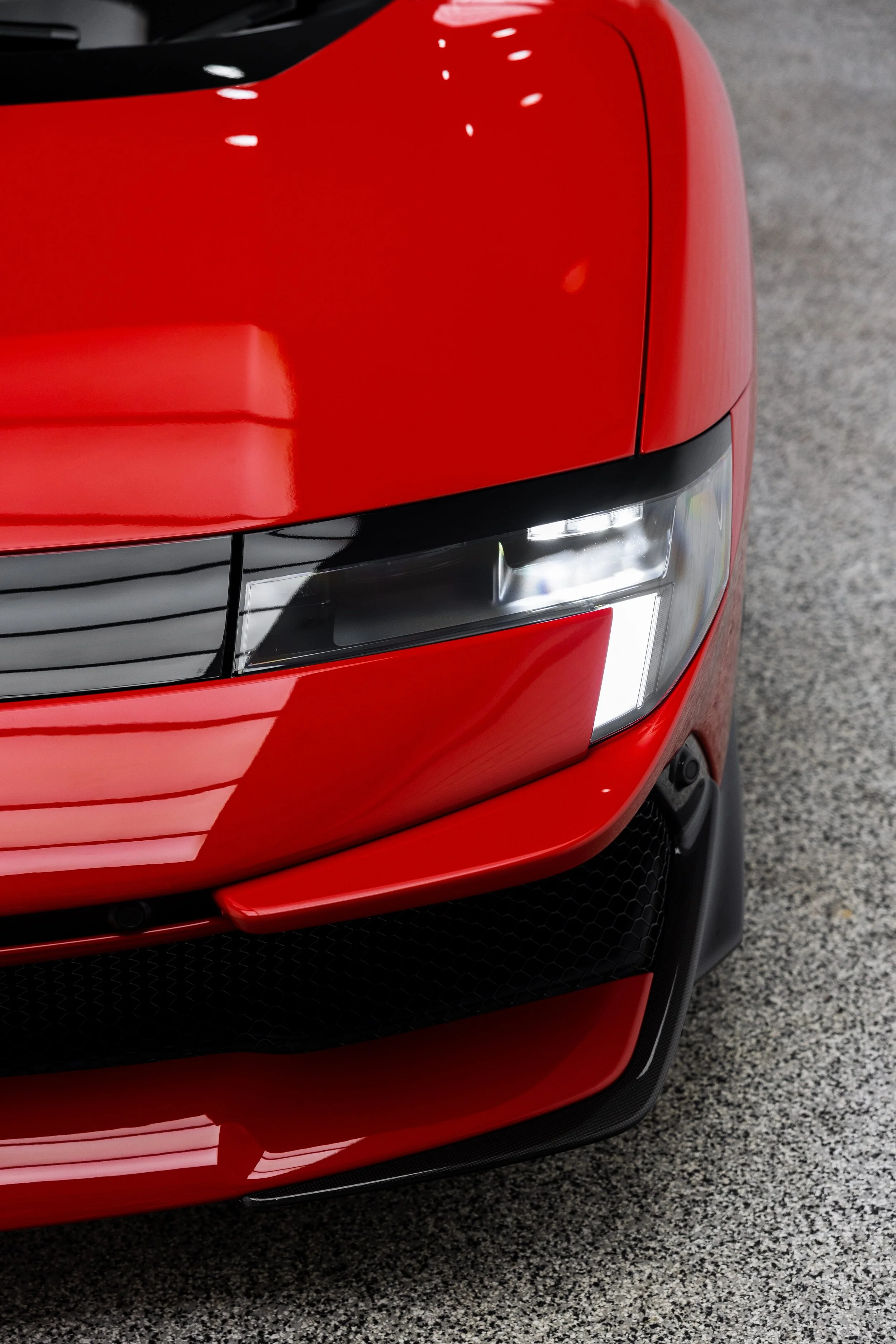 Red Ferrari 849 Testarossa headlight and front bumper with XPEL Paint Protection Film in Mona Vale