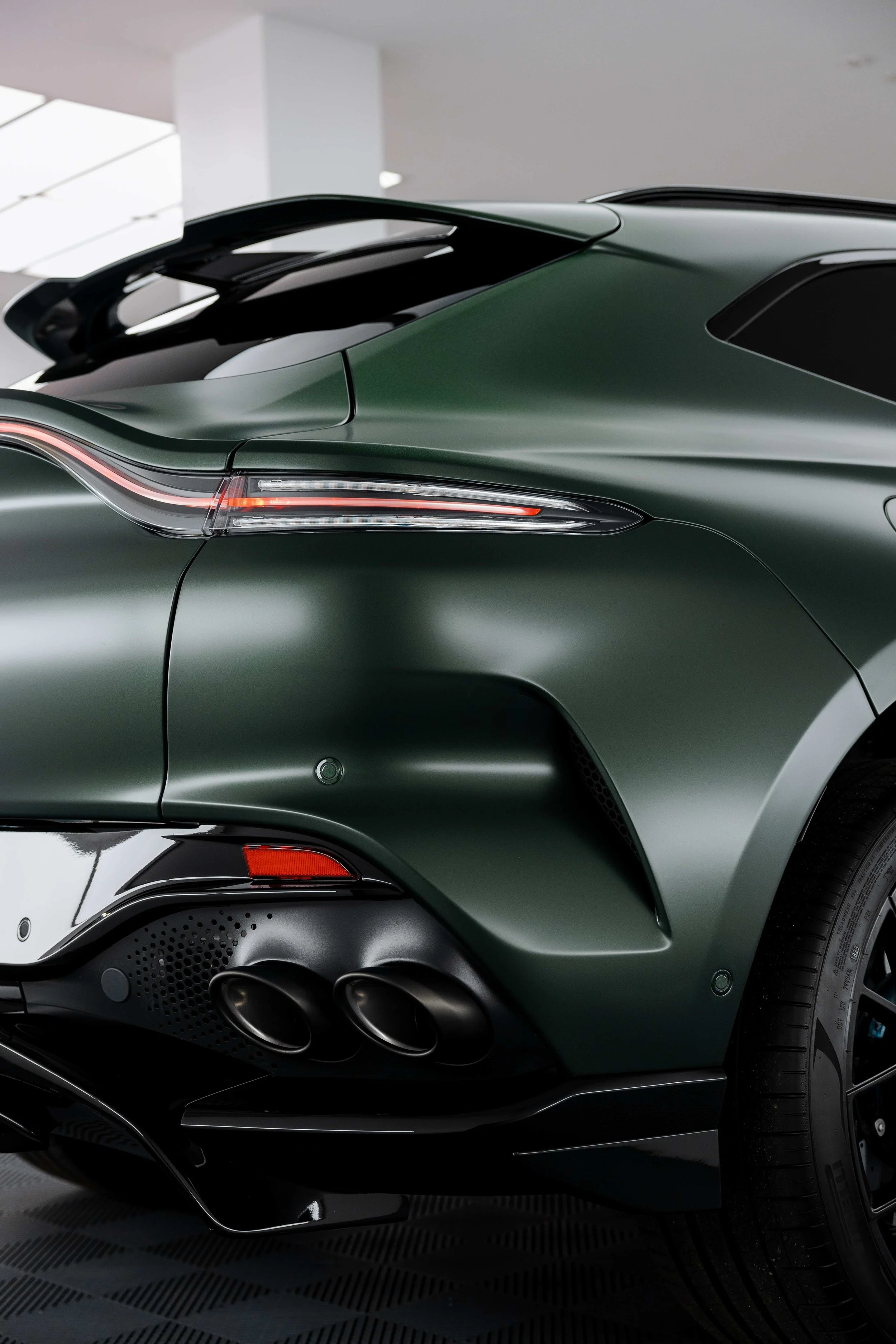 Matte green Aston Martin DBX rear quarter and exhaust with XPEL Stealth Paint Protection Film in Mona Vale