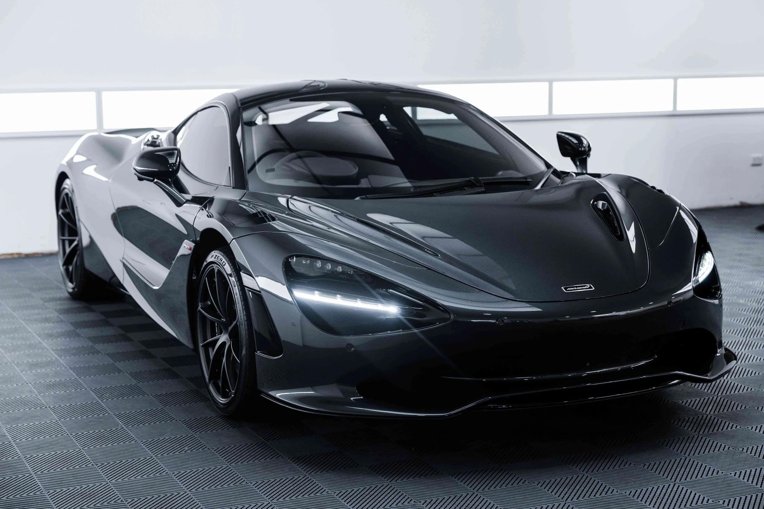 Black McLaren 750S front three quarter in studio with XPEL Paint Protection Film in Sydney