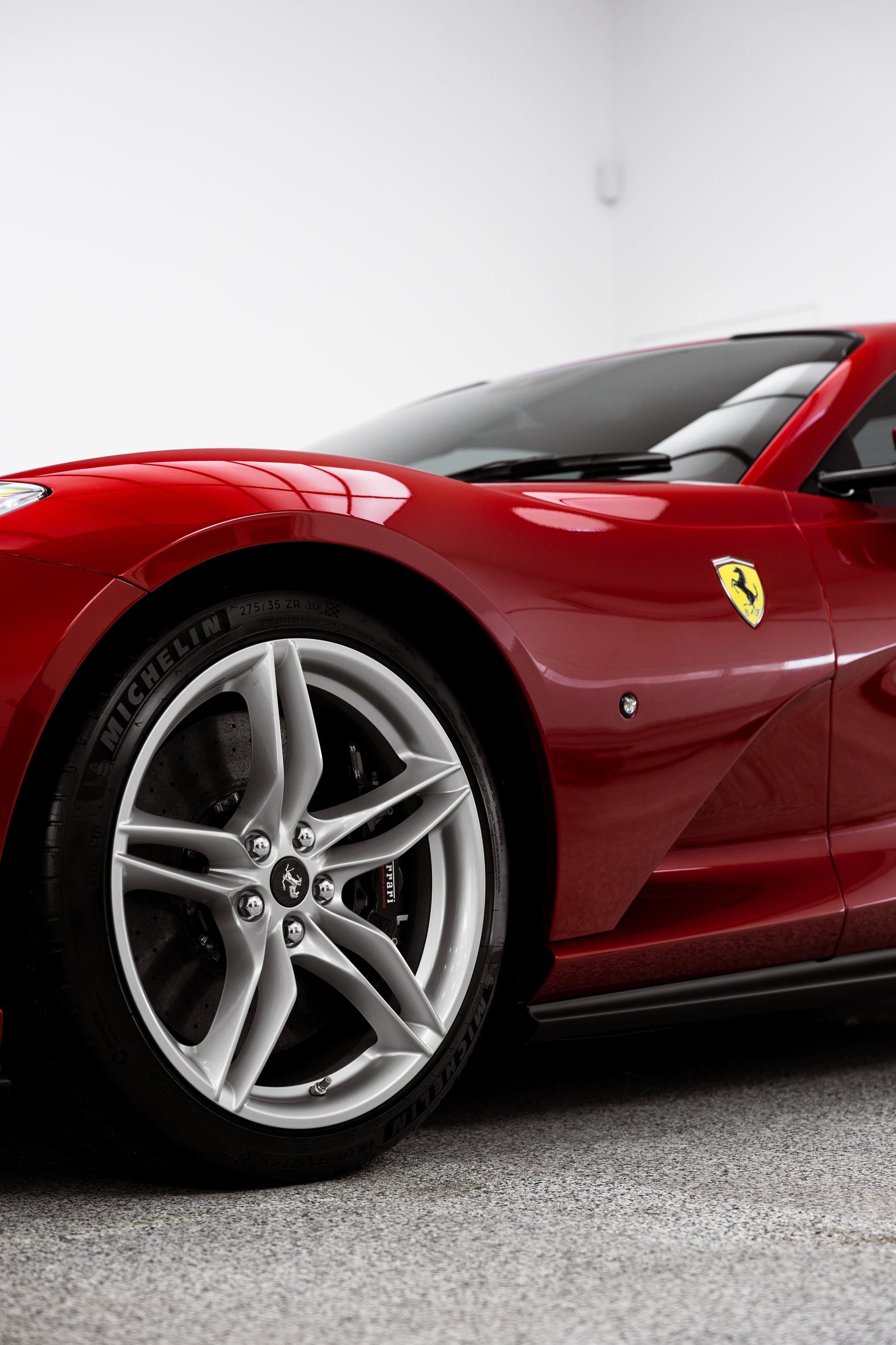 Red Ferrari 812 GTS side profile with alloy wheel and fender detail protected by PPF and ceramic coating by ADS in Sydney