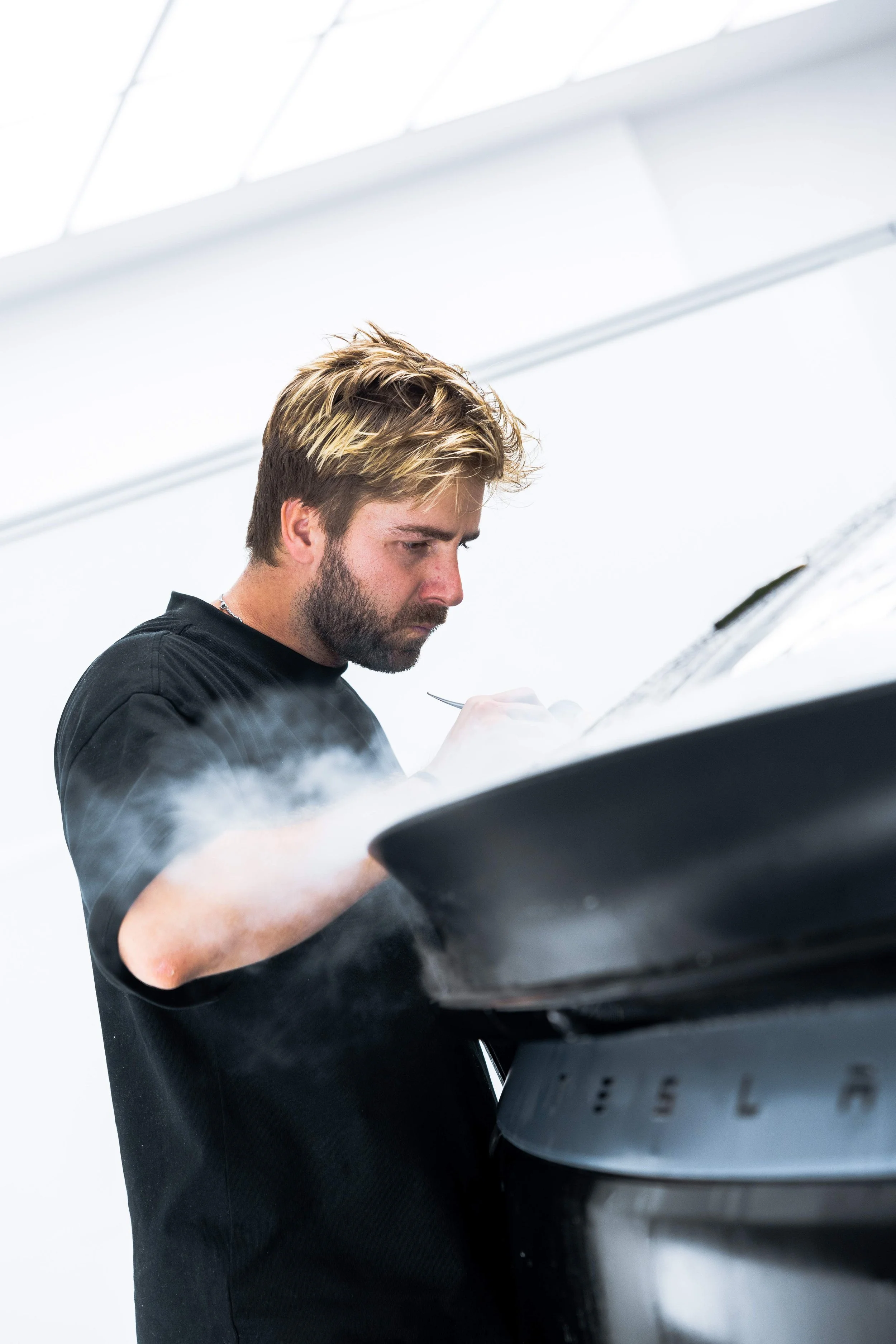 ADS technician trimming XPEL Stealth Paint Protection Film on Tesla Model Y bonnet in Sydney