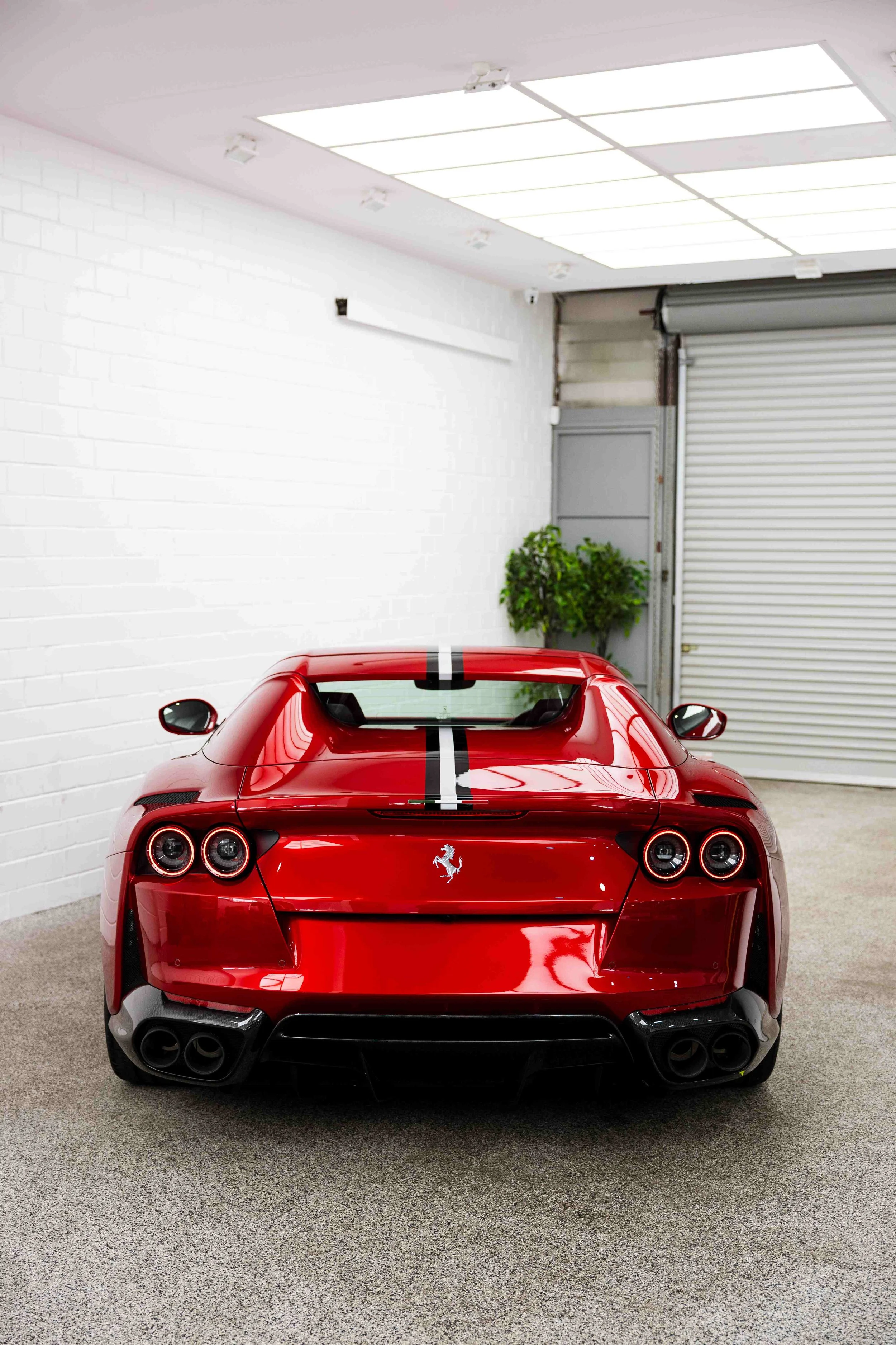 Red Ferrari 812 GTS rear view with racing stripe and XPEL Paint Protection Film in Mona Vale