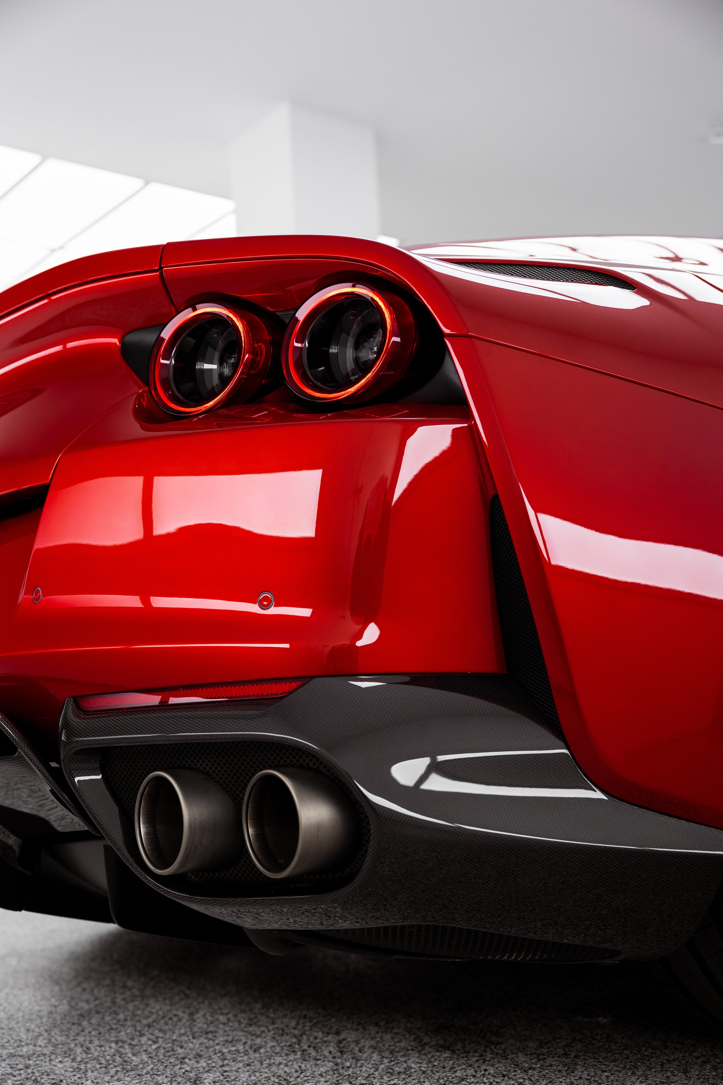 Red Ferrari 812 GTS rear detail with dual exhaust and LED tail lights protected with PPF by ADS in Sydney