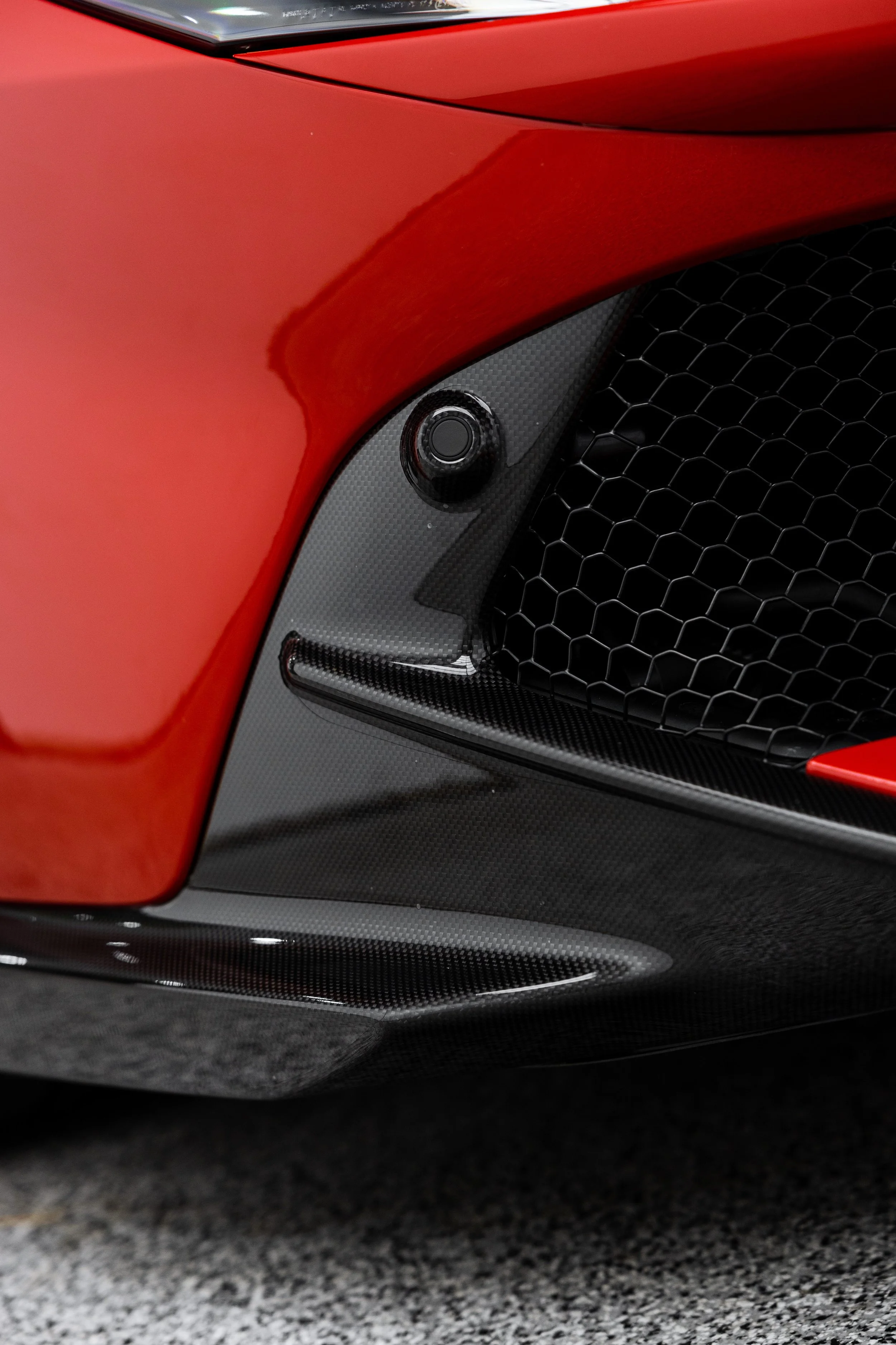 Red Ferrari 849 Testarossa front bumper and carbon fibre splitter with XPEL Paint Protection Film in Mona Vale