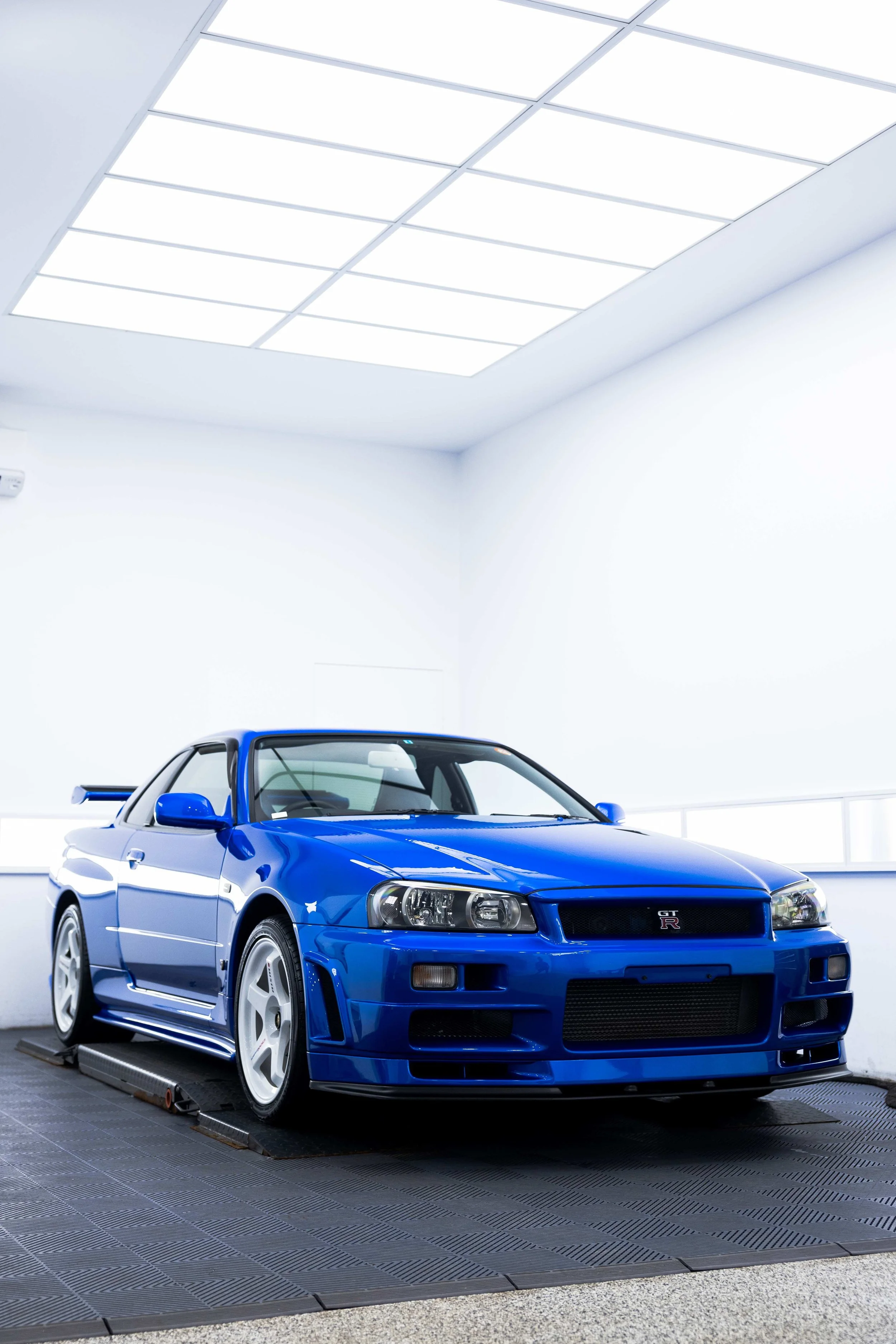 Bayside blue Nissan R34 GT-R Nur front three quarter view with XPEL Paint Protection Film in Mona Vale