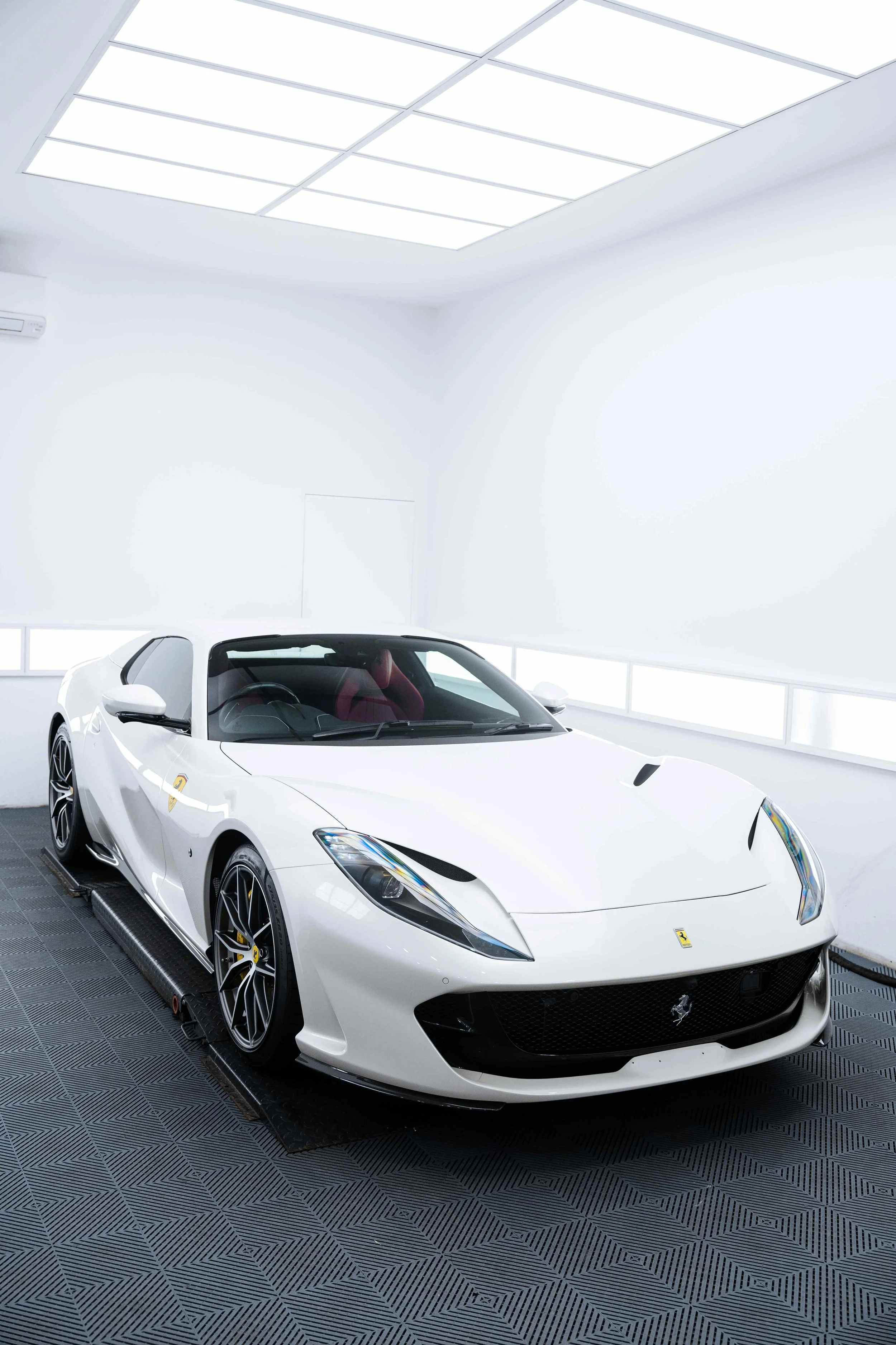 White Ferrari 812 GTS front three quarter in studio with XPEL Paint Protection Film in Mona Vale