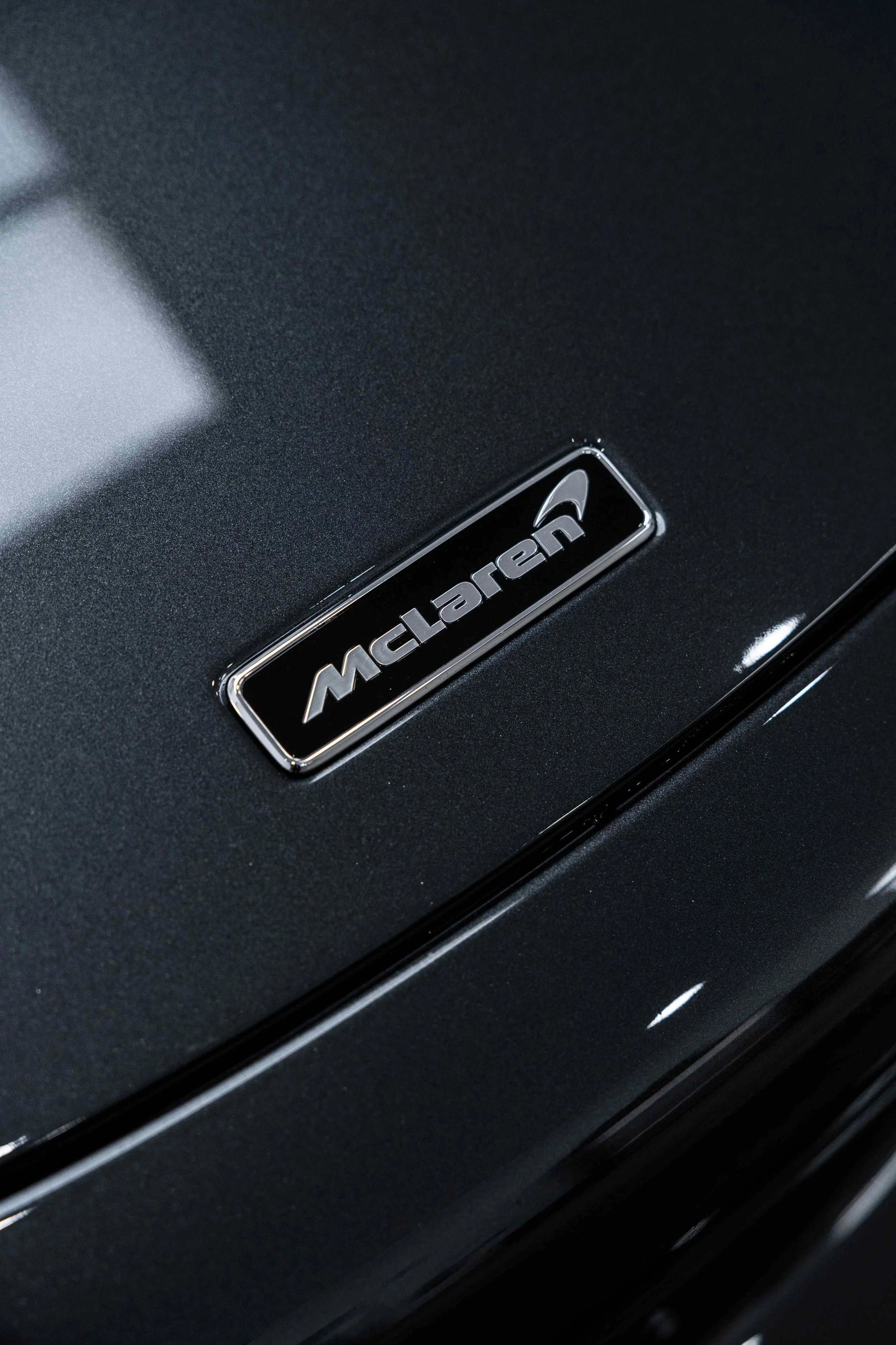 Black McLaren 750S rear badge detail with XPEL Paint Protection Film in Sydney