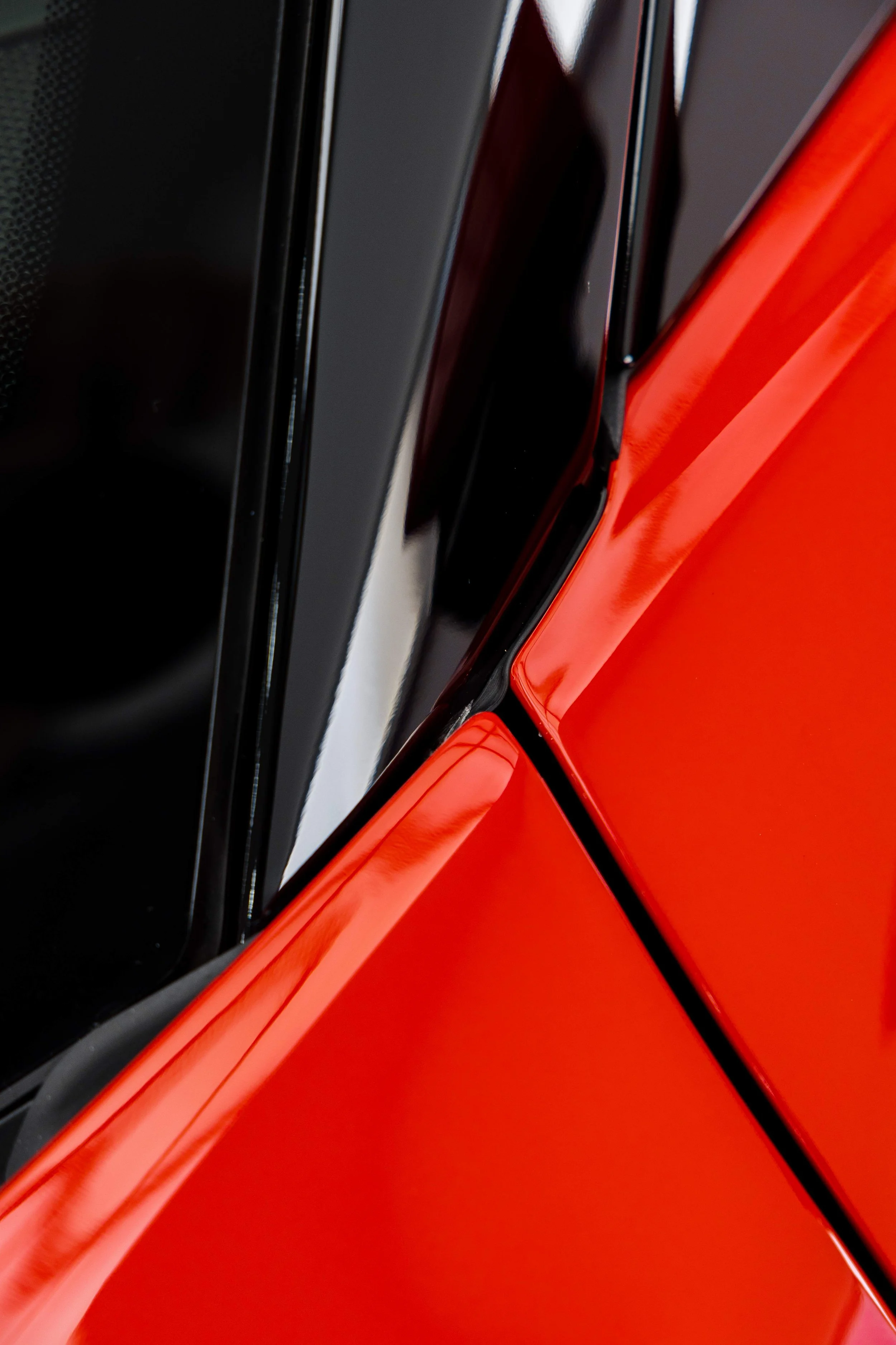Red Ferrari SF90 Spyder A pillar and front guard detail with XPEL Paint Protection Film in Mona Vale