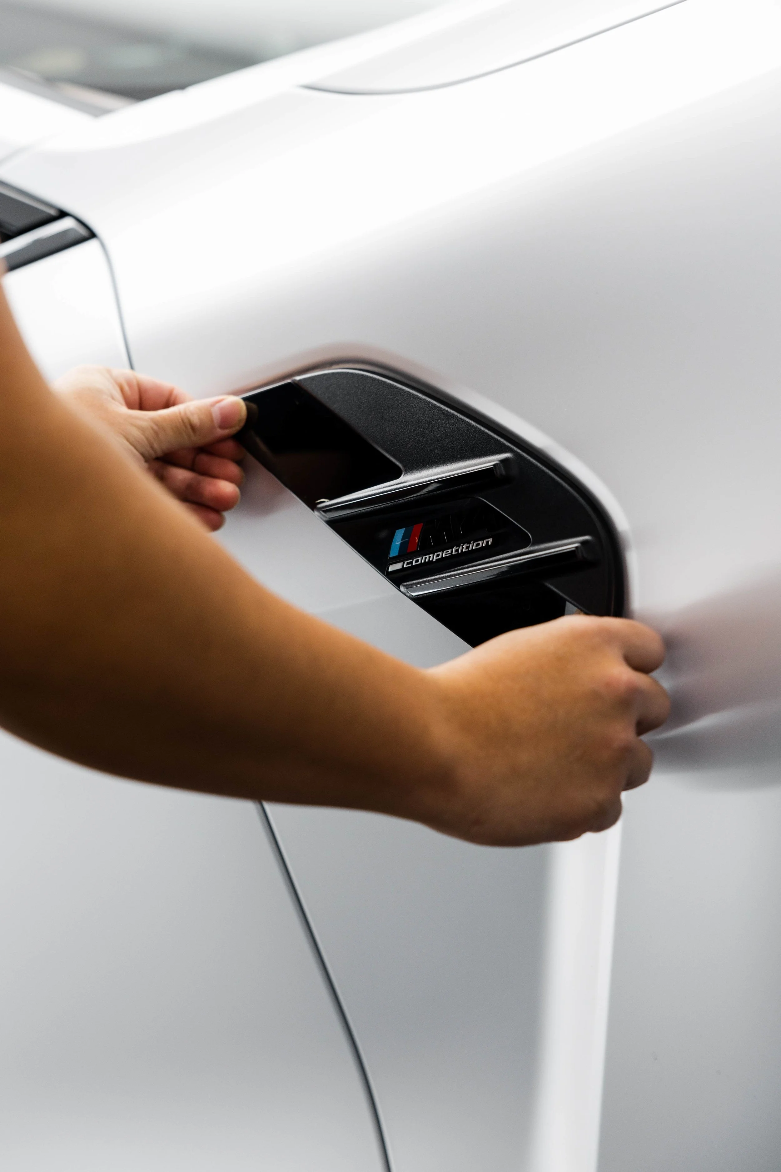 ADS technician fitting XPEL Paint Protection Film to BMW M4 Competition side vent in Sydney