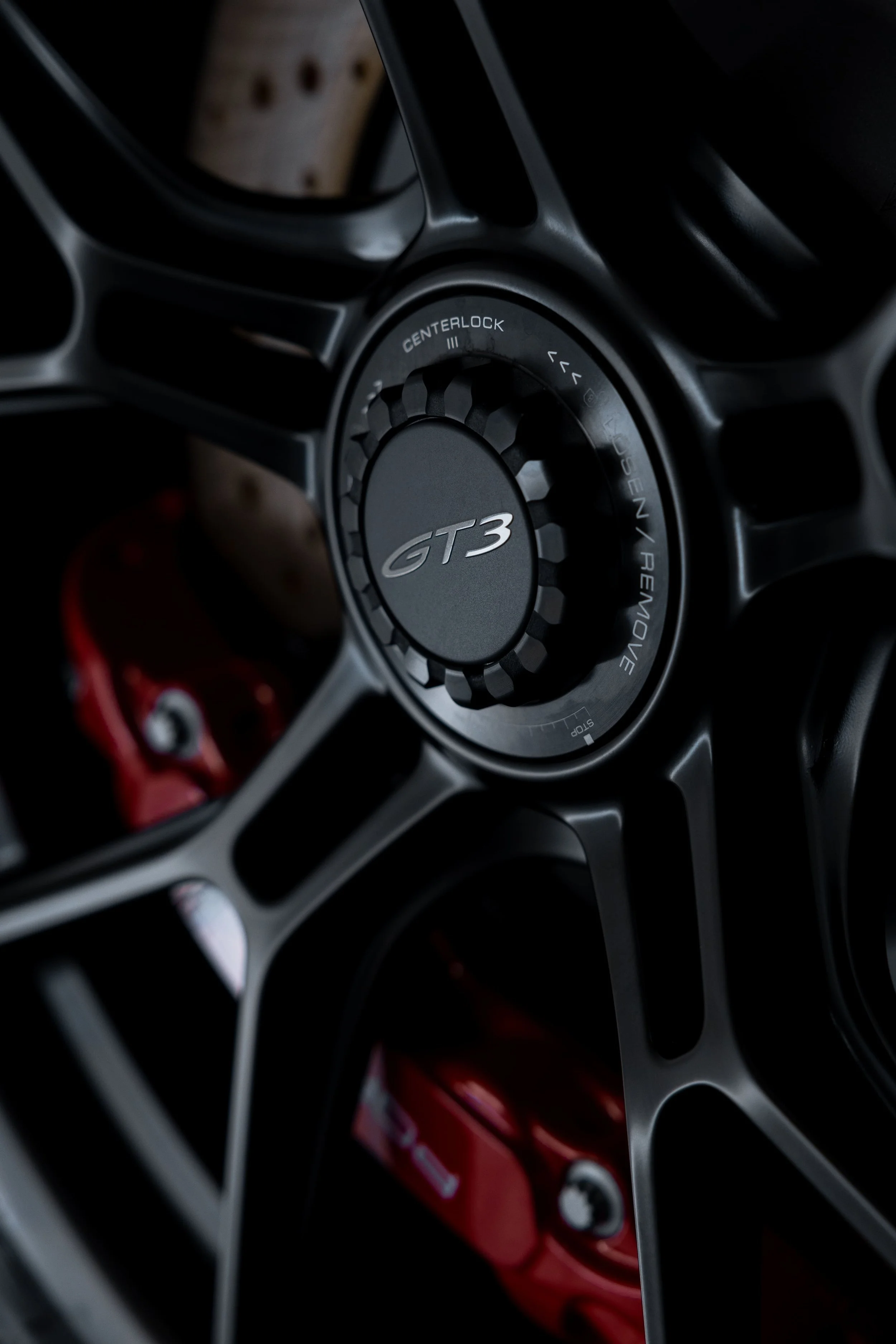 Close-up of Porsche 911 GT3 centre lock wheel with red brake caliper and full PPF protection by ADS in Mona Vale