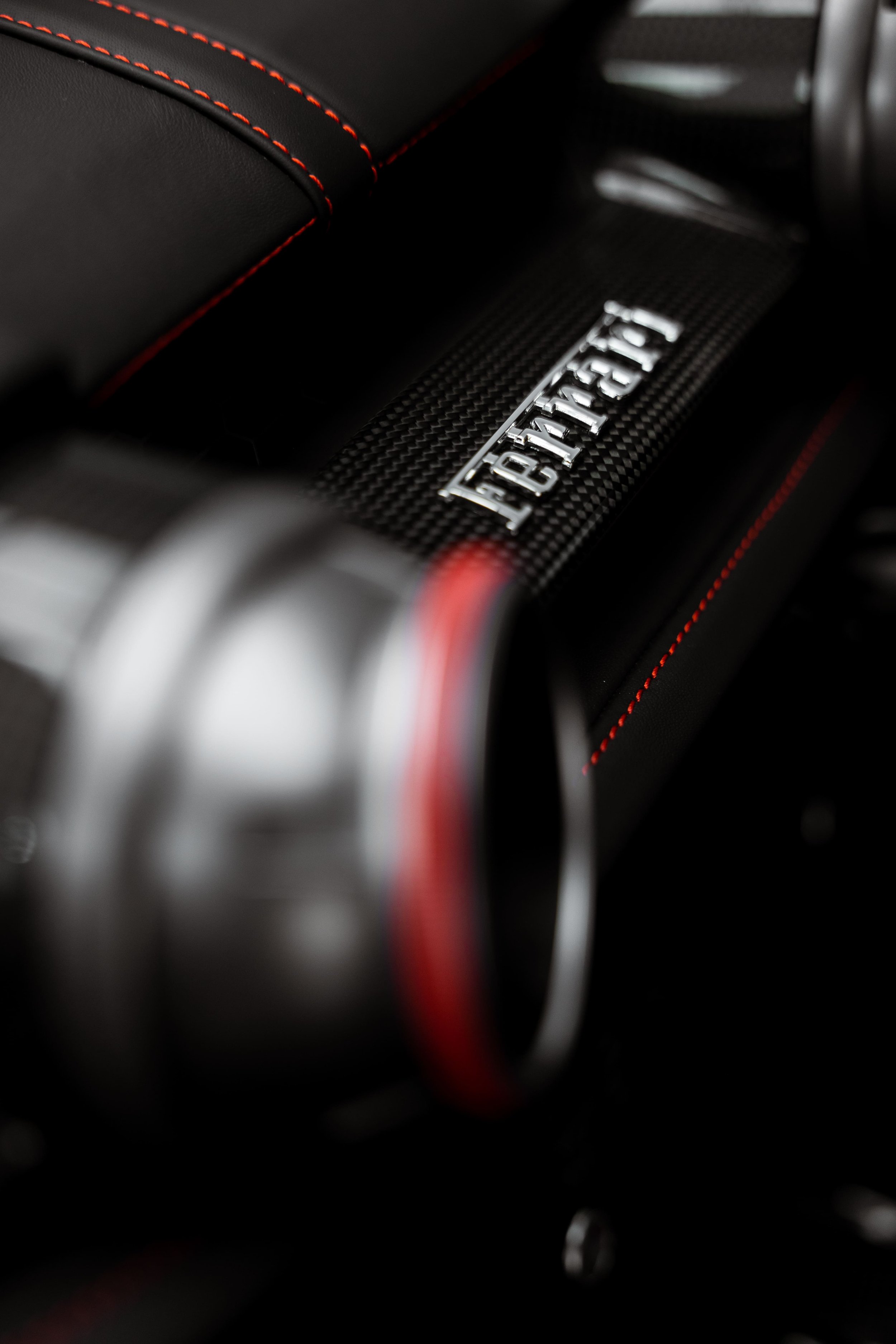 Ferrari 812 GTS interior carbon fibre trim with Ferrari badge and red stitching detail by ADS in Sydney