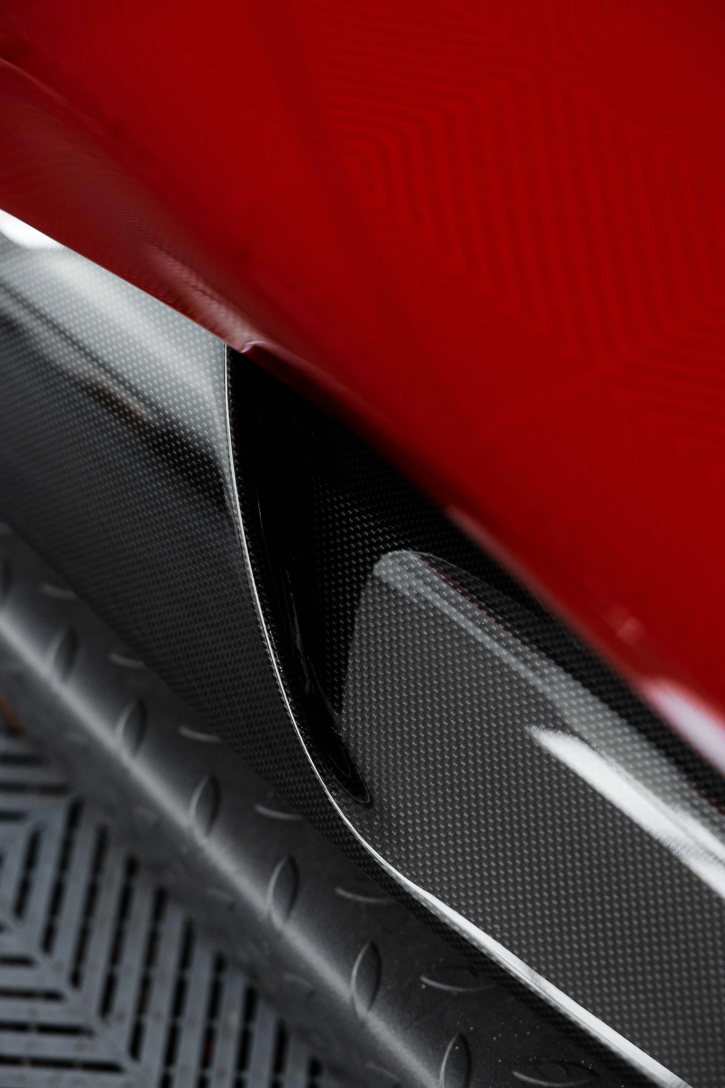 Red Ferrari 296 Speciale carbon fibre side skirt and rear guard detail in Sydney