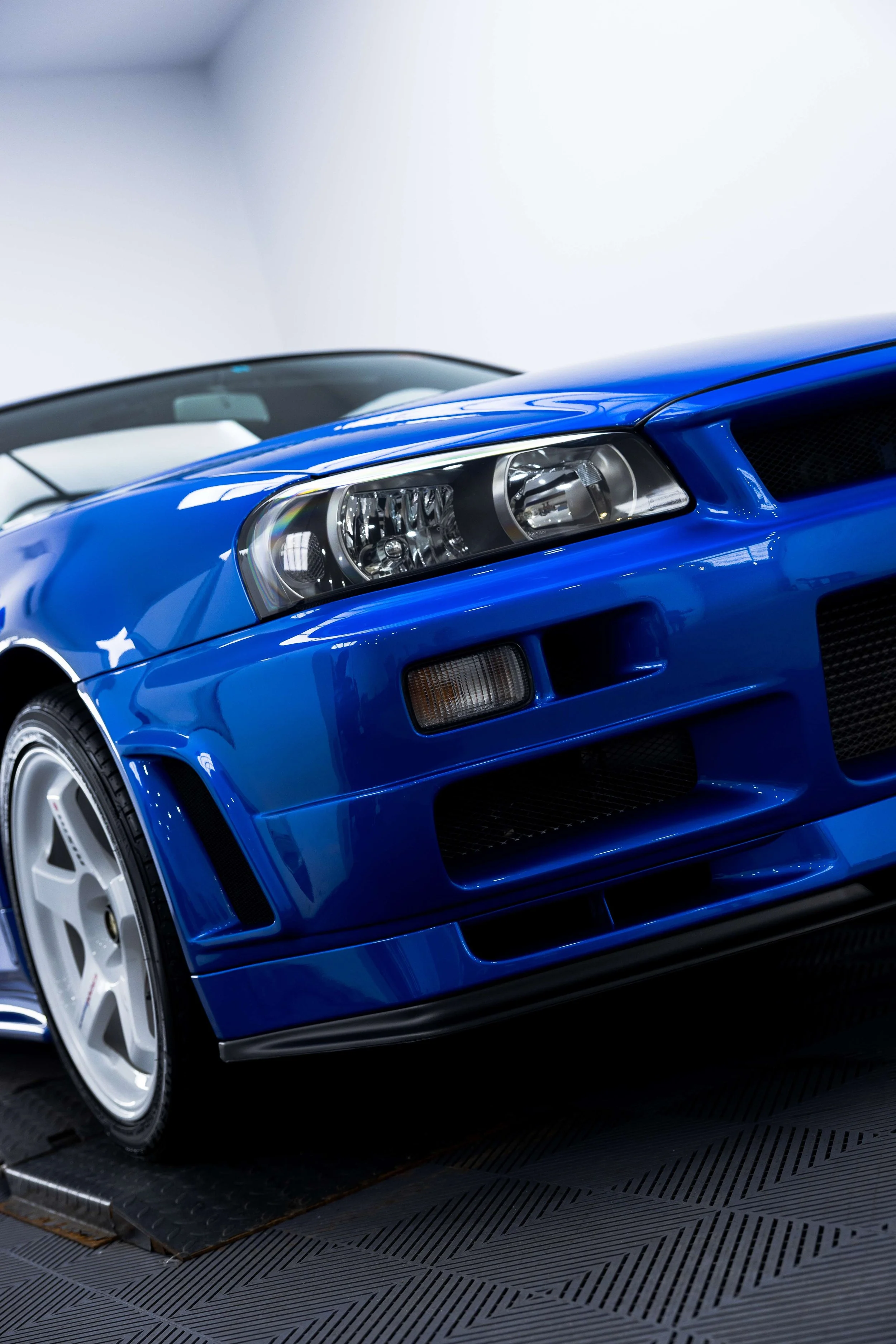 Bayside blue Nissan R34 GT-R Nur front bumper and wheel with XPEL Paint Protection Film in Mona Vale