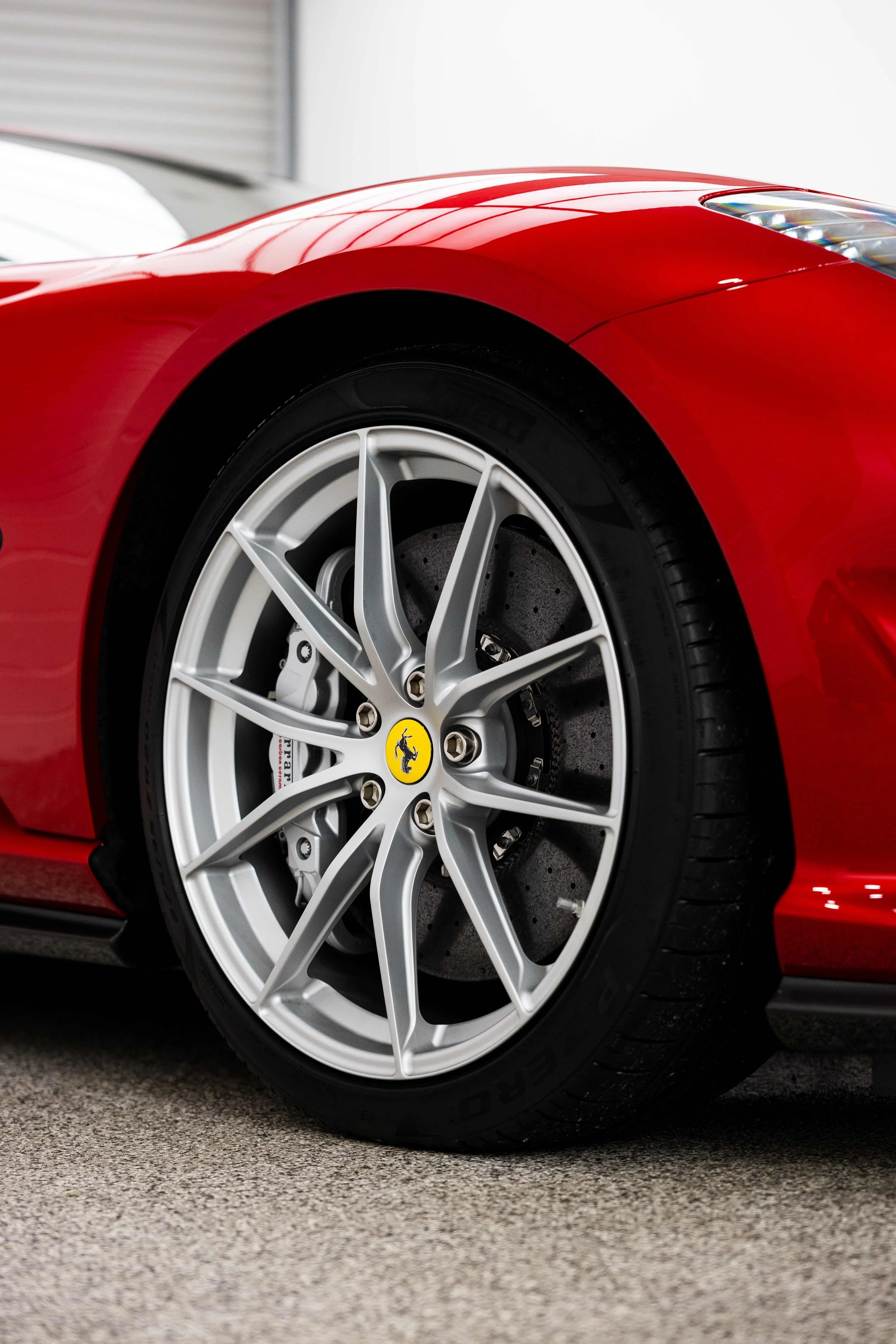 Red Ferrari 812 GTS front wheel and brake caliper with XPEL Paint Protection Film in Sydney