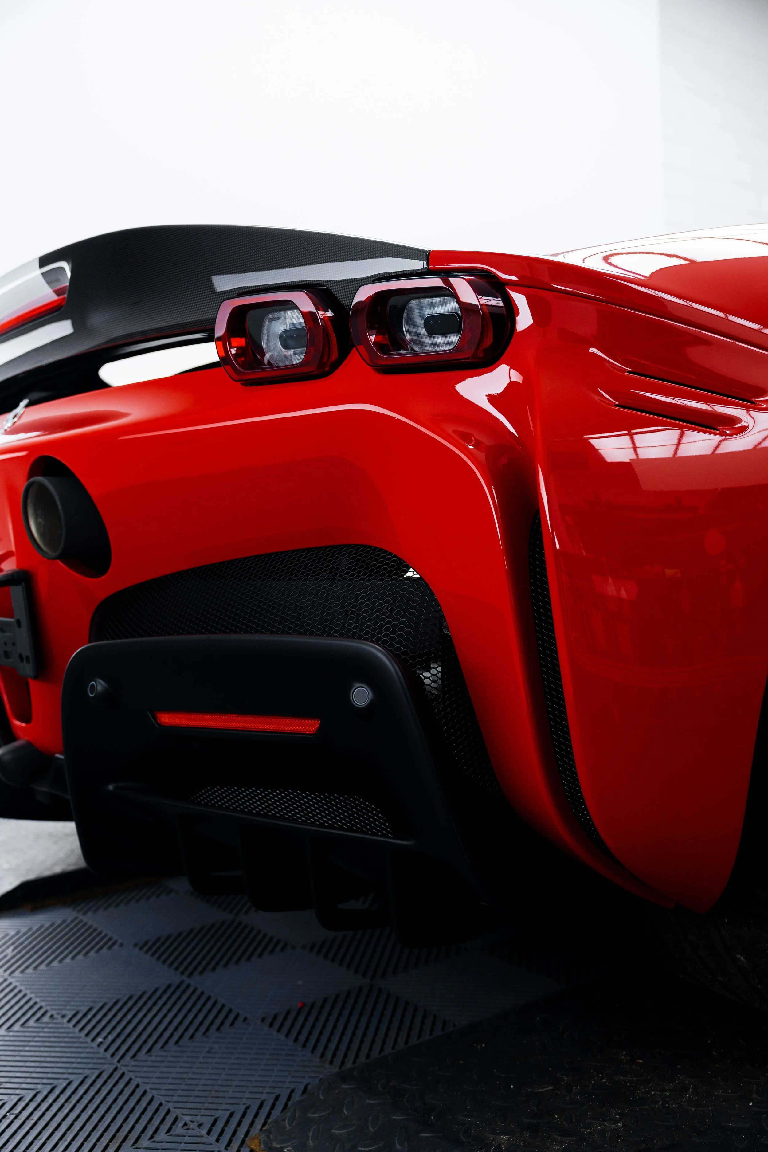 Red Ferrari SF90 Spyder rear quarter, taillight and diffuser with XPEL Paint Protection Film in Mona Vale